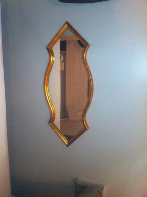 Gold leafed wood beveled frame mirror with double arrow design. Shape is after middle eastern forms or Moroccan architecture. 