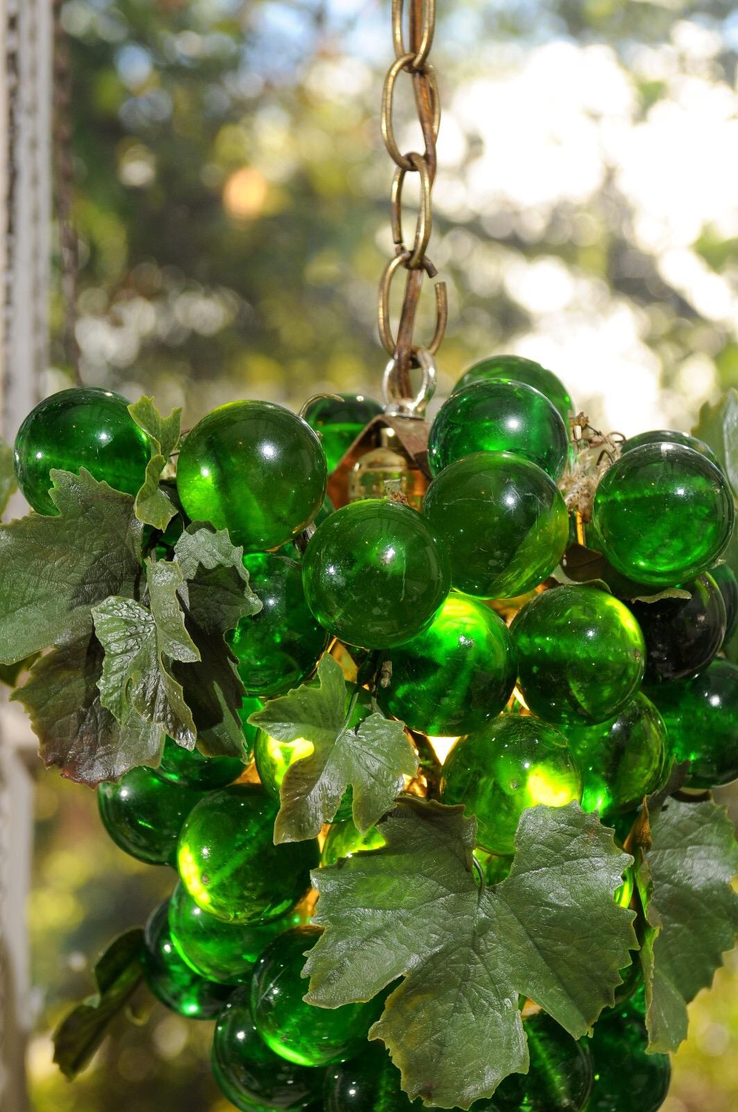 Vintage iconic grape cluster swag light made of Lucite orbs, acrylic leaves, and the original vintage brass chain of 11' in length.