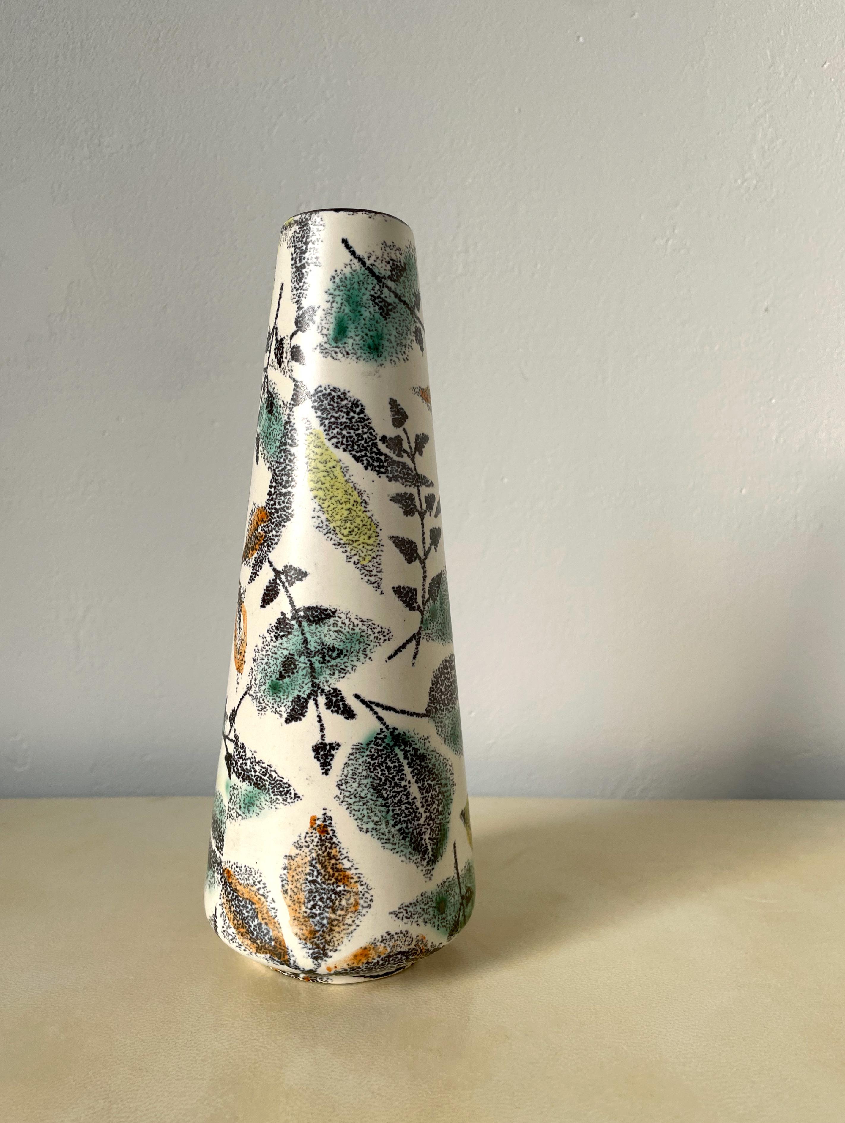 Midcentury modern vase with graphic dotted, organic, floral decor on white base. Decorative leaves in green, yellow, red colors. Manufactured in the late 1960s. Stamped under base. Beautiful vintage condition.