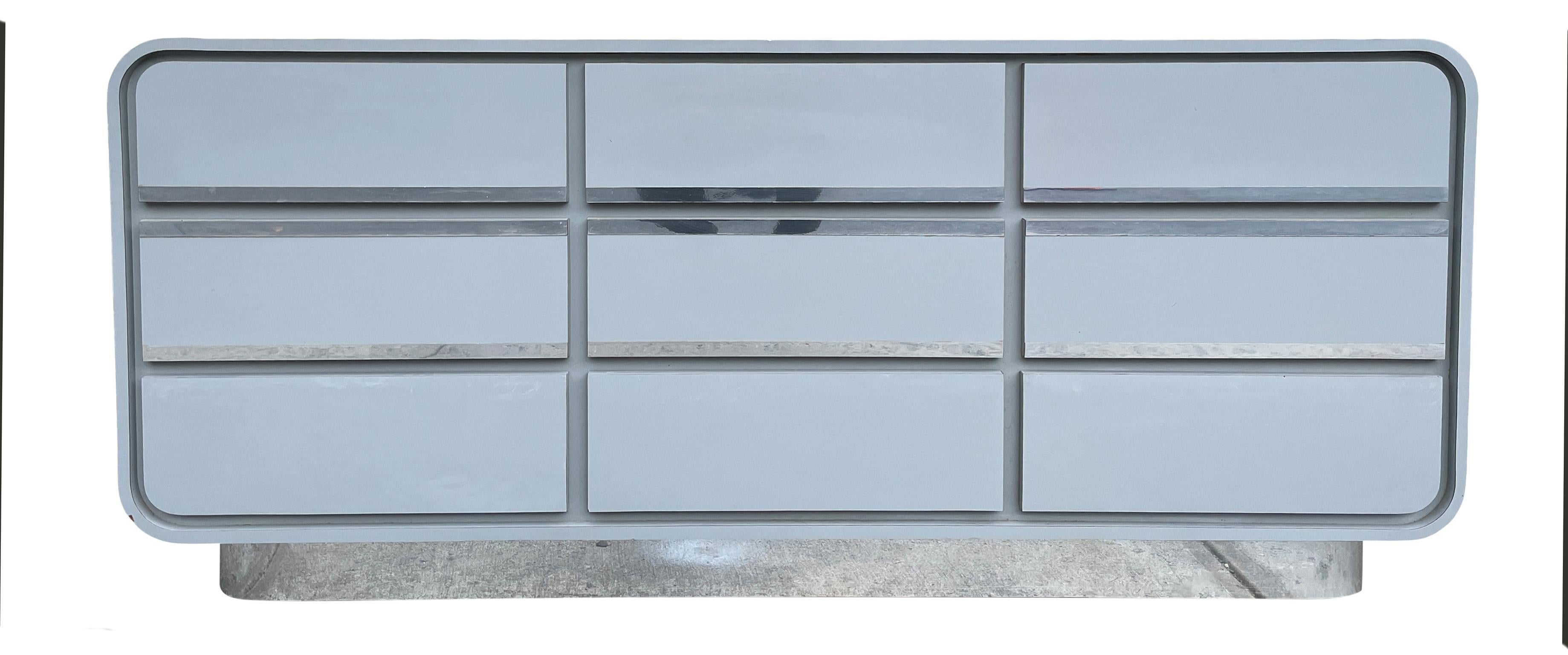 Very long matte white grayish blue gloss laminate and chrome trim waterfall design custom 9 drawer dresser credenza, circa 1980s custom made. Very clean inside and out. Look at photos. This unit is built very high quality sturdy and structural all
