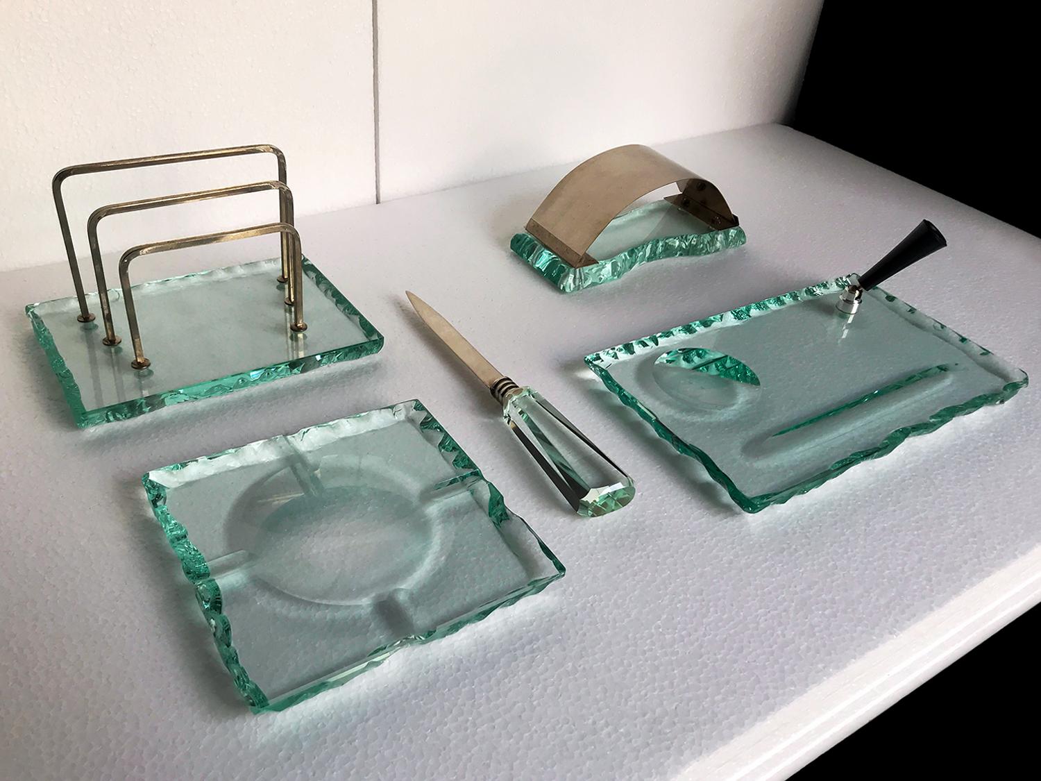 Stunning crystal desk set produced by Fontana Arte in the 1950s and attributable to the design of Pietro Chiesa.
All items are handmade and chiseled using thick glass colored 'green Nilo', characteristic of the production of glassware manufactured
