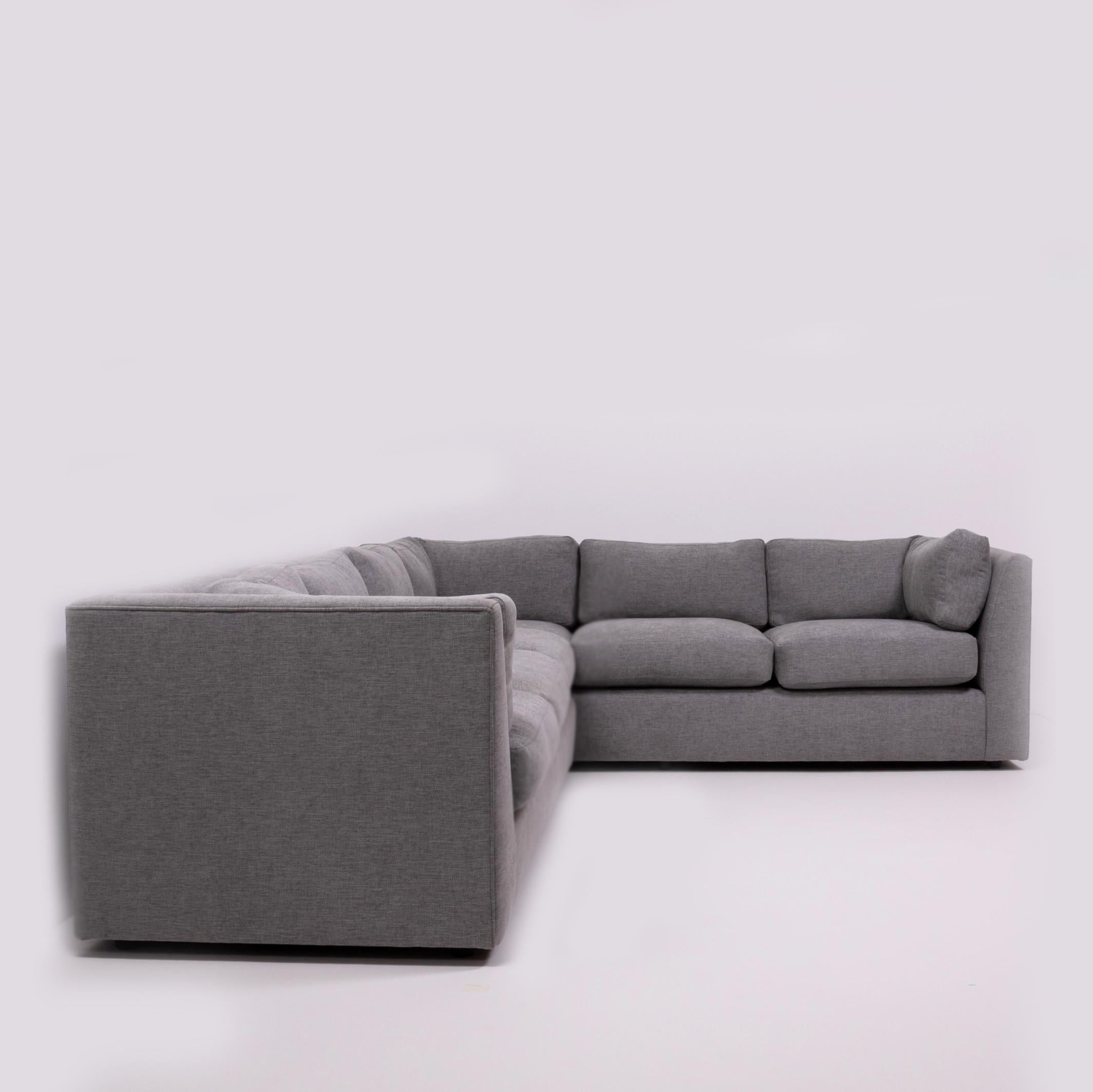 Sleek and simple, this Milo Baughman sectional corner sofa has been newly reupholstered in grey Linara fabric.

Comprising of a three-seat sofa unit and a separate corner unit, the sofa features a slim frame with deep comfortable seating and round