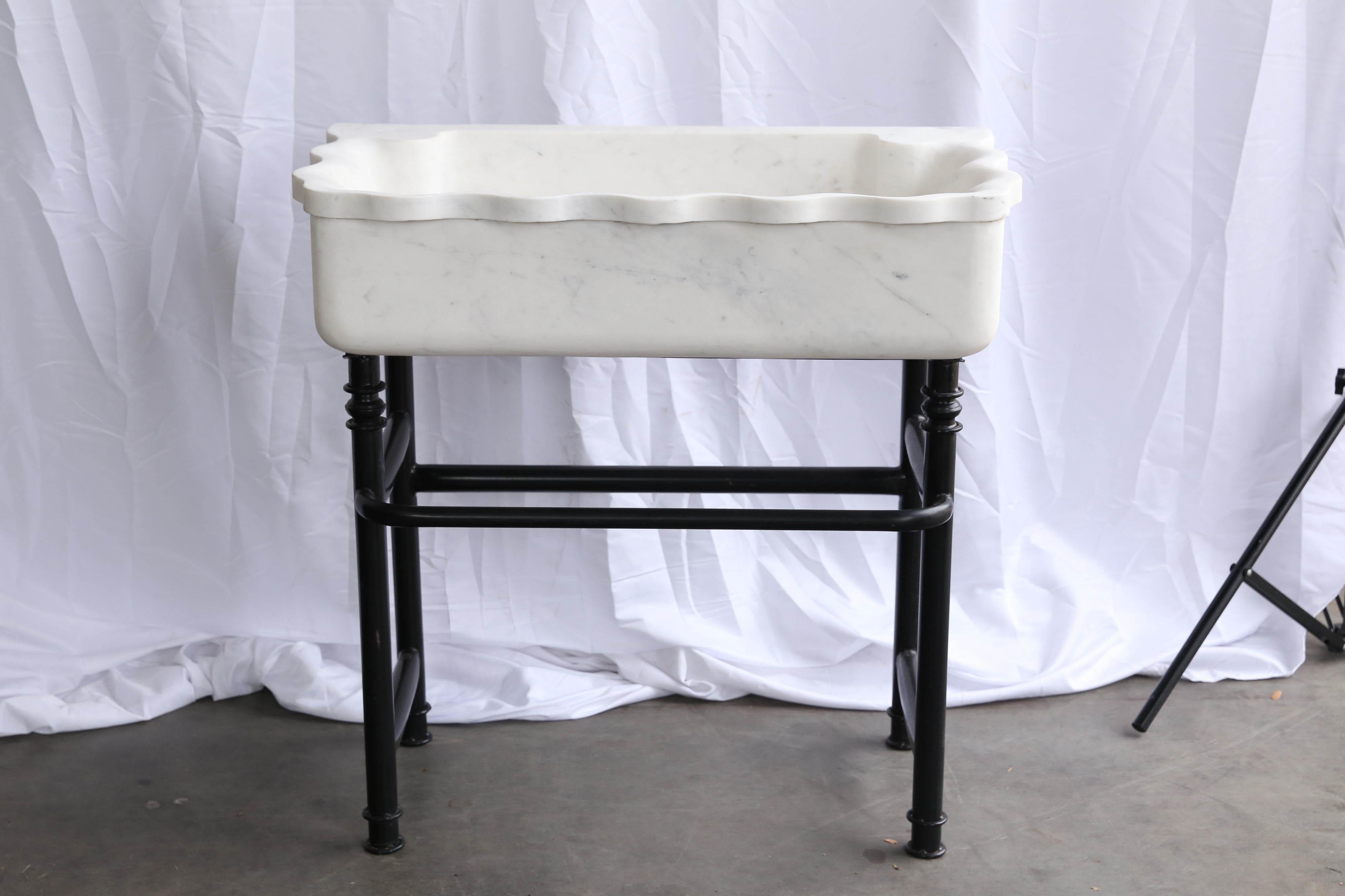 Marble sinks on iron stands were used in the open backyard of colonial homes.
The large marble sink is hand-carved from one block of large fine quality marble slab. The support is made of iron and has a towel rack. It is solid and will last several