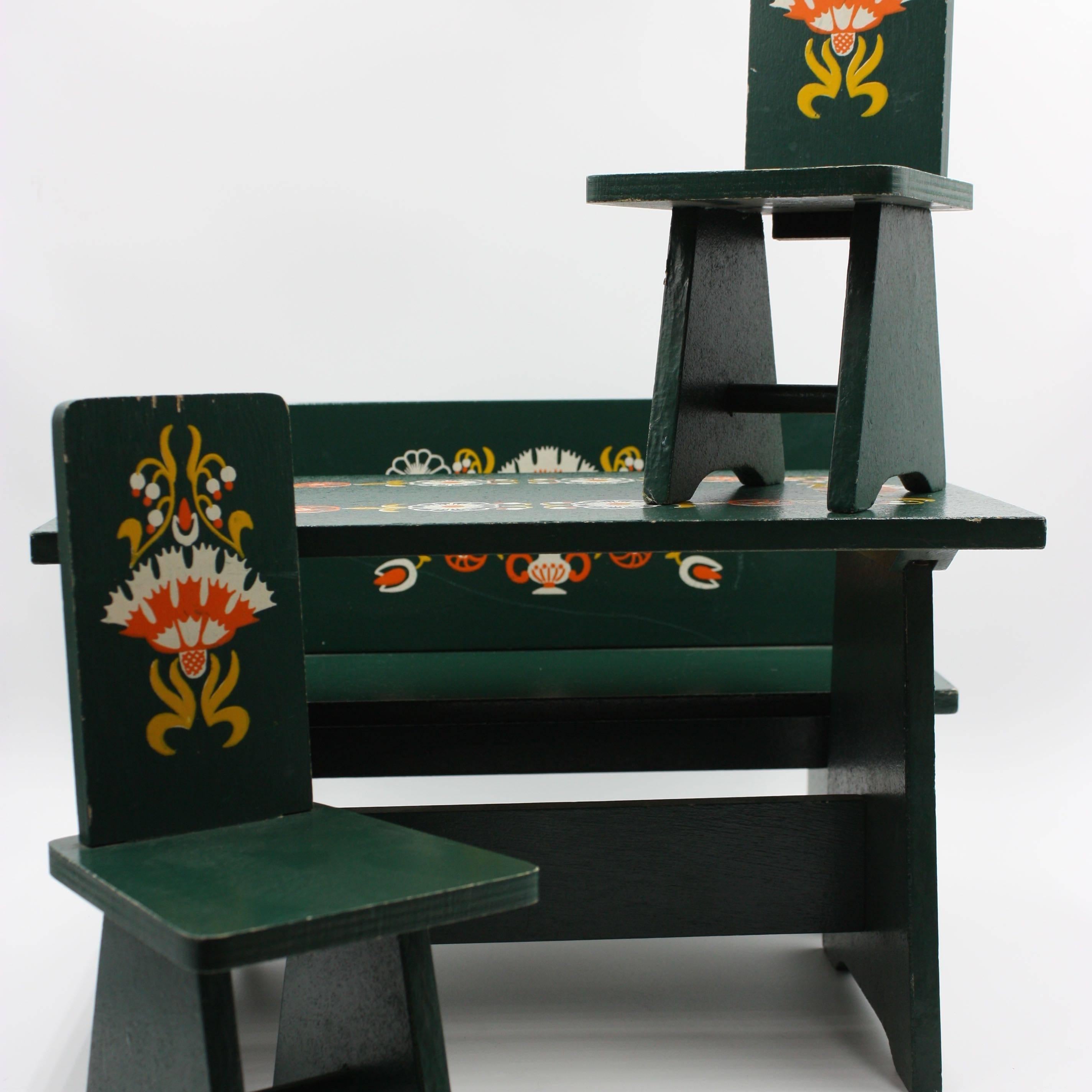 Hand-painted floral motif green dolls furniture from the 1940s in the style of Dora Kuhn.
Complete dining room set with a bench, two chair, table an China cabinet. Chest of drawers and a wardrobe. 
 