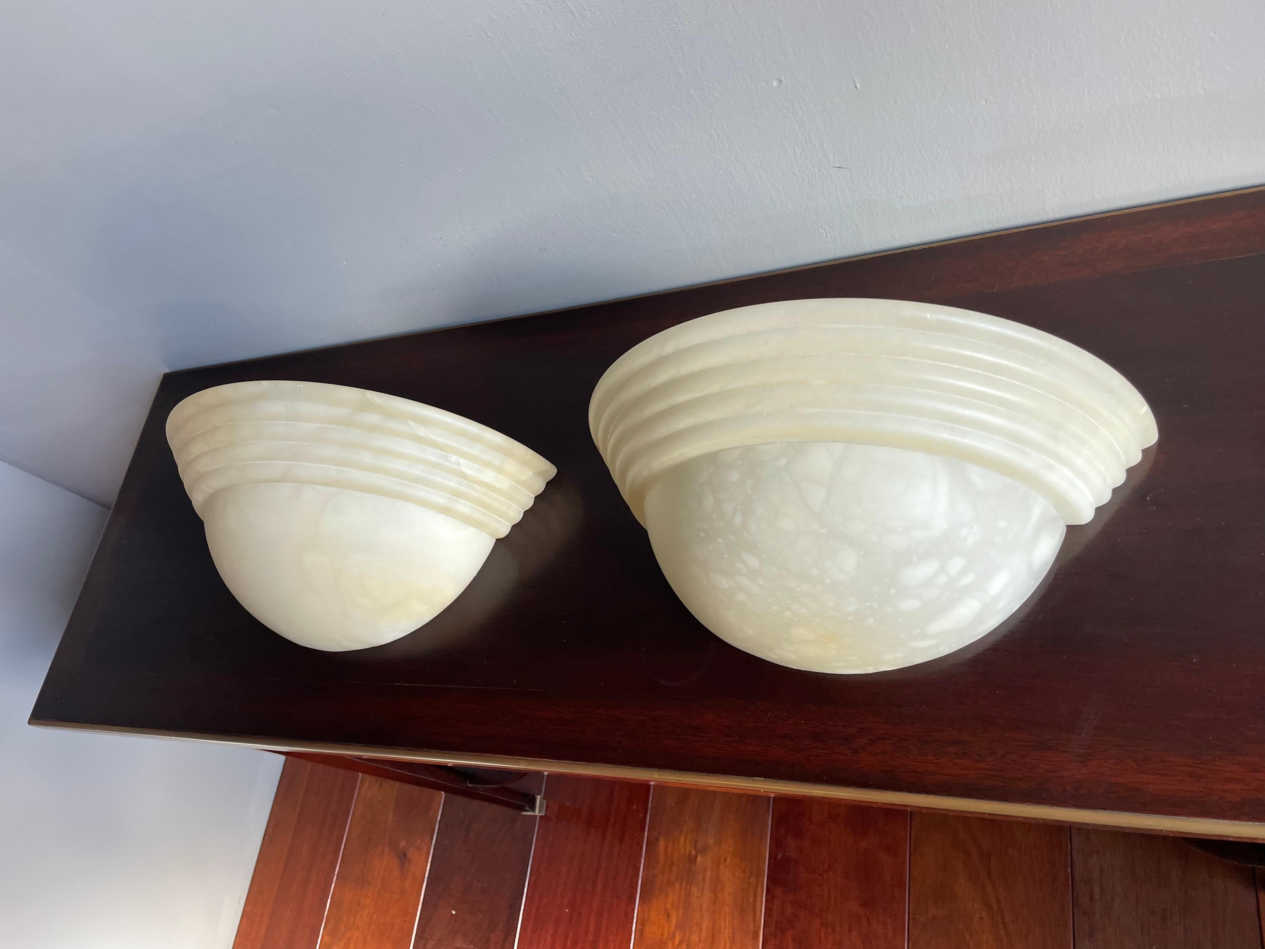 Great looking, easy to mount and beautifully handcrafted pair of alabaster wall lights.

If you are looking for a stylish and timeless way to bring light into your entry hall, bathroom, kitchen or bedroom or if you are looking for the perfect wall