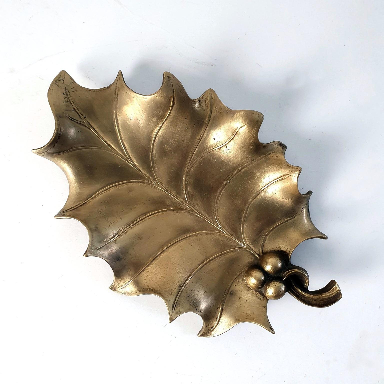 A large and heavy set handmade bronze tray in the shape of a holly leaf. Perfect for candy, snacks, fruit, keys or simply for decorative purposes.
