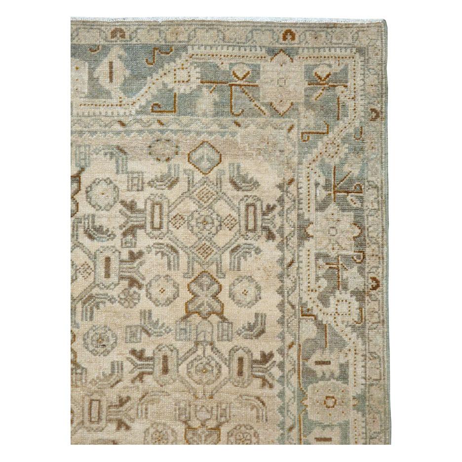 A vintage Persian Malayer accent rug handmade during the mid-20th century with a cream-colored field and a border with color variations from greyed out blueish green tones.

Measures: 4' 7