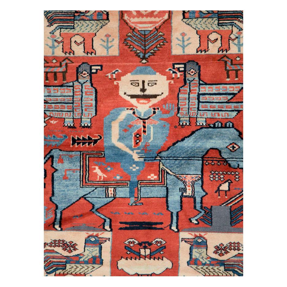 A vintage Persian Hamadan rug handmade during the mid-20th century with a pictorial depiction of what seems to be a historical figure on his horse surrounded by 4 large peacocks and other smaller animals. Folk pieces like this are woven by village