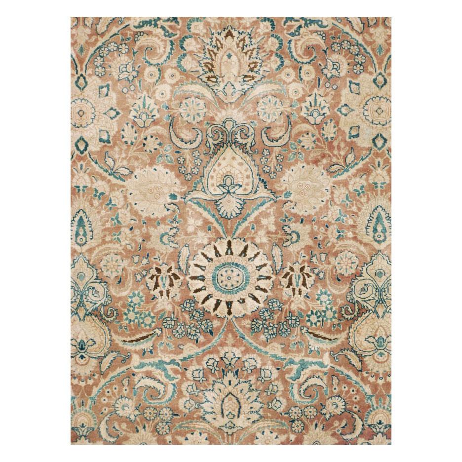 A vintage Persian Tabriz room size area rug handmade during the mid-20th century with a dense arabesque all-over pattern within the soft-toned burnt umber field and the green border.

Measures: 10' 4