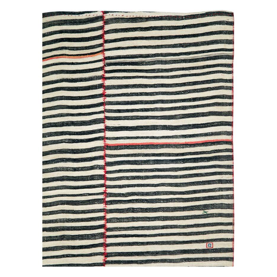 A vintage Persian flat-weave Kilim accent rug handmade during the mid-20th century. Three sections of Zebra printed black and white are conjoined by red stitching. The left column is quirky and offset in comparison to the other two due to its