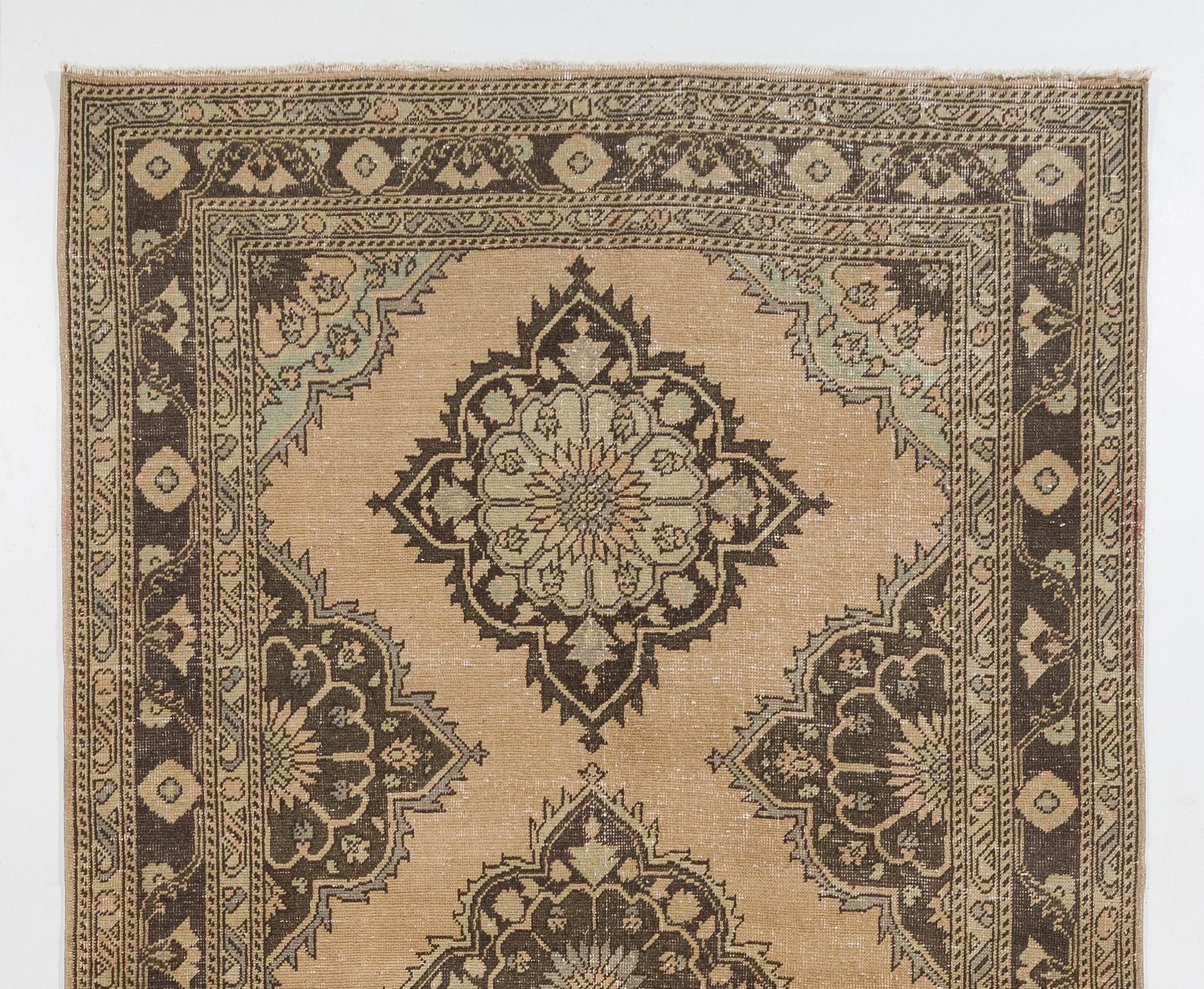 A vintage Turkish runner rug. It was hand knotted in the 1950s and multiple medallion design. Sturdy and can be used on a high traffic area, suitable for both residential and commercial interiors. Measures: 5x12.8 Ft.