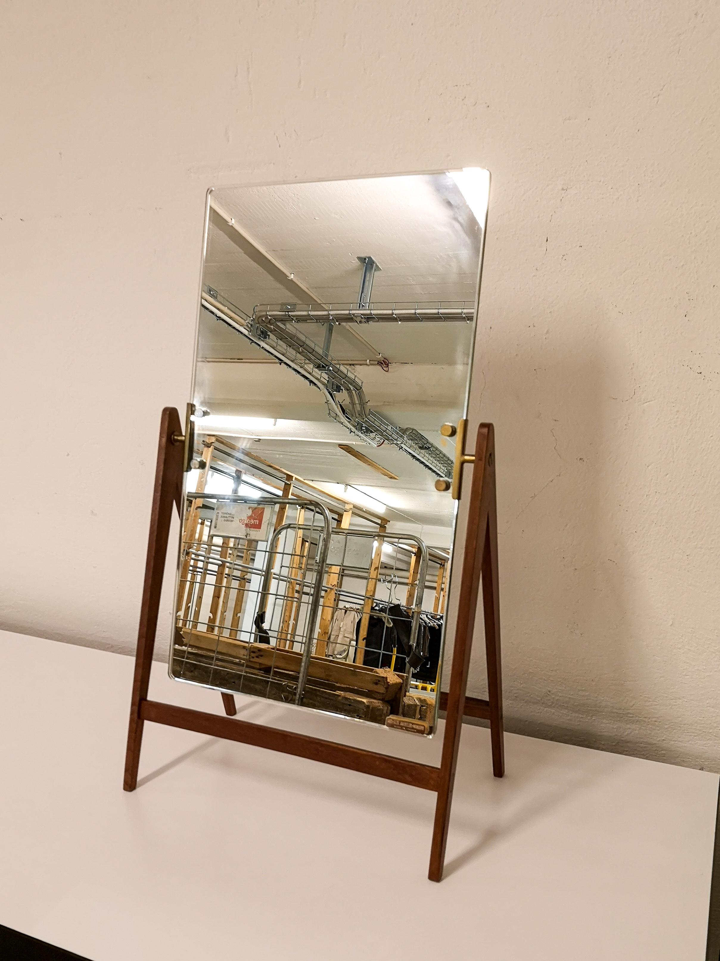 This rare midcentury table mirror in brass and teak was produced in Sweden at AB Markaryd and designed by Hans-Agne Jakobsson. The mirror stands on a teak foundation and has a swinging mode to be able to adjust the position. The brass details and