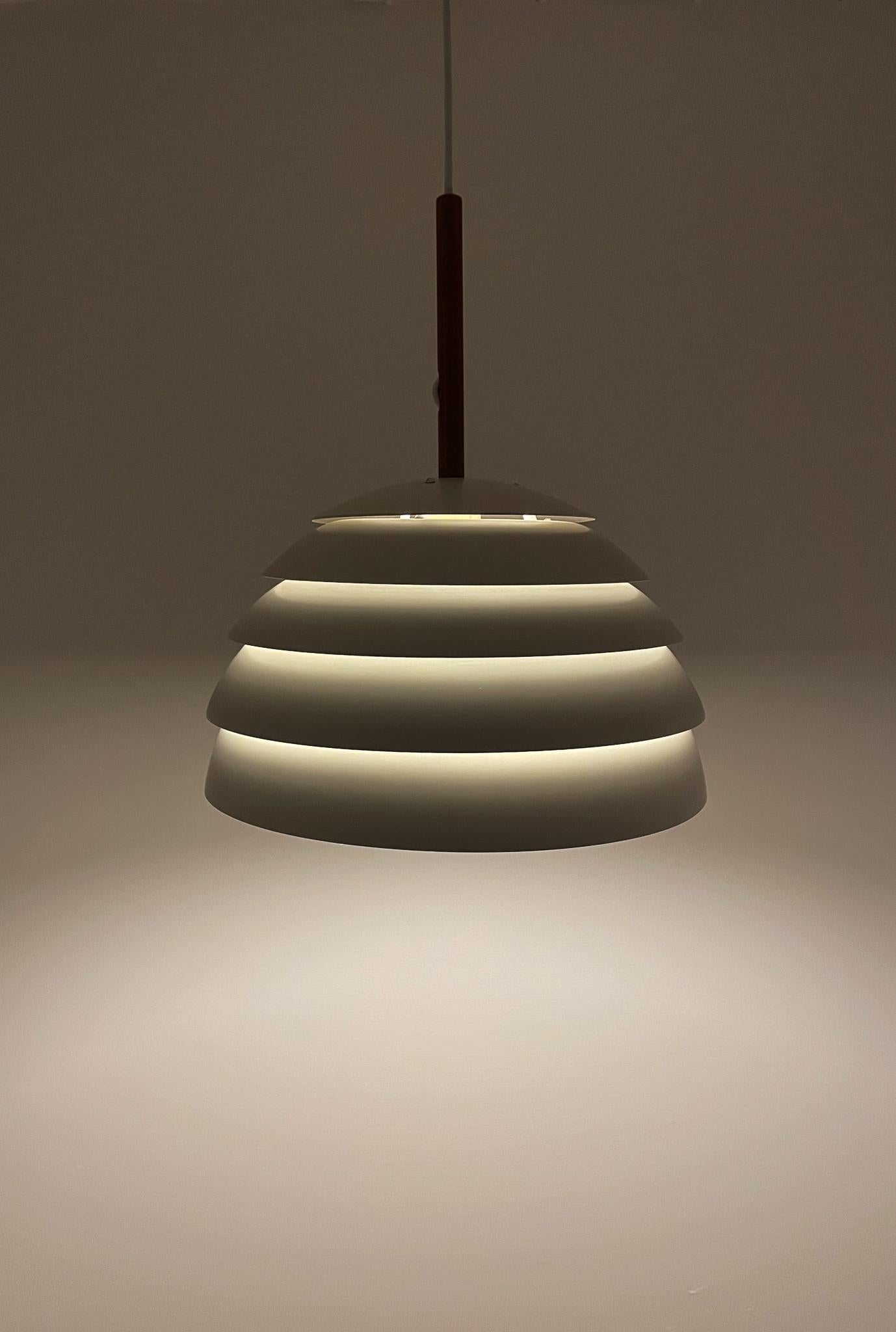 
Model Lamingo T325 is a minimalistic design lamp that is designed to distribute the light without glare in the eyes. The lamp provides a beautiful subtle light and will look beautifully above a dining room table. Made with a teak rod and painted