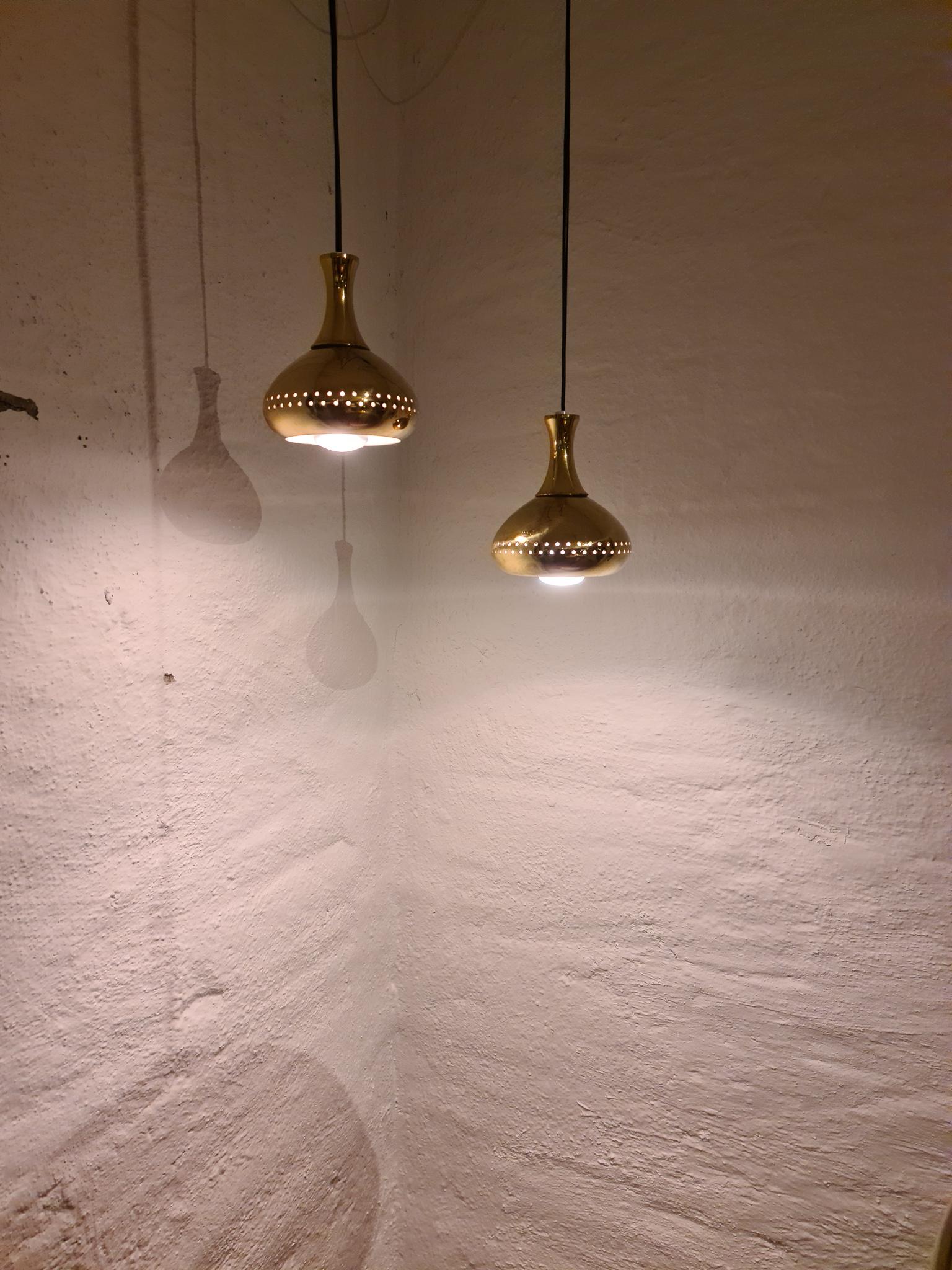 Nicely shaped brass pendants designed by famous Swedish designer Hans Agne Jakobsson. Gives a beautiful shine and a cozy light. 

Good vintage condition. New wiring

Measures Height 6.7 in. (17 cm), diameter 5.52 in. (14 cm).

