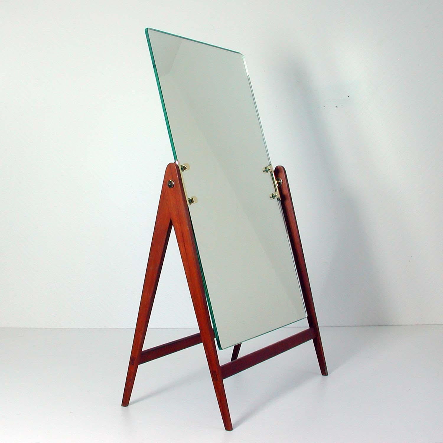 This large table mirror was designed by Hans-Agne Jakobsson and manufactured by Markaryd in Sweden in the 1960s. 
It has got a teak base and an adjustable mirror with brass details. It has also got it´s original tag.

Condition is excellent.