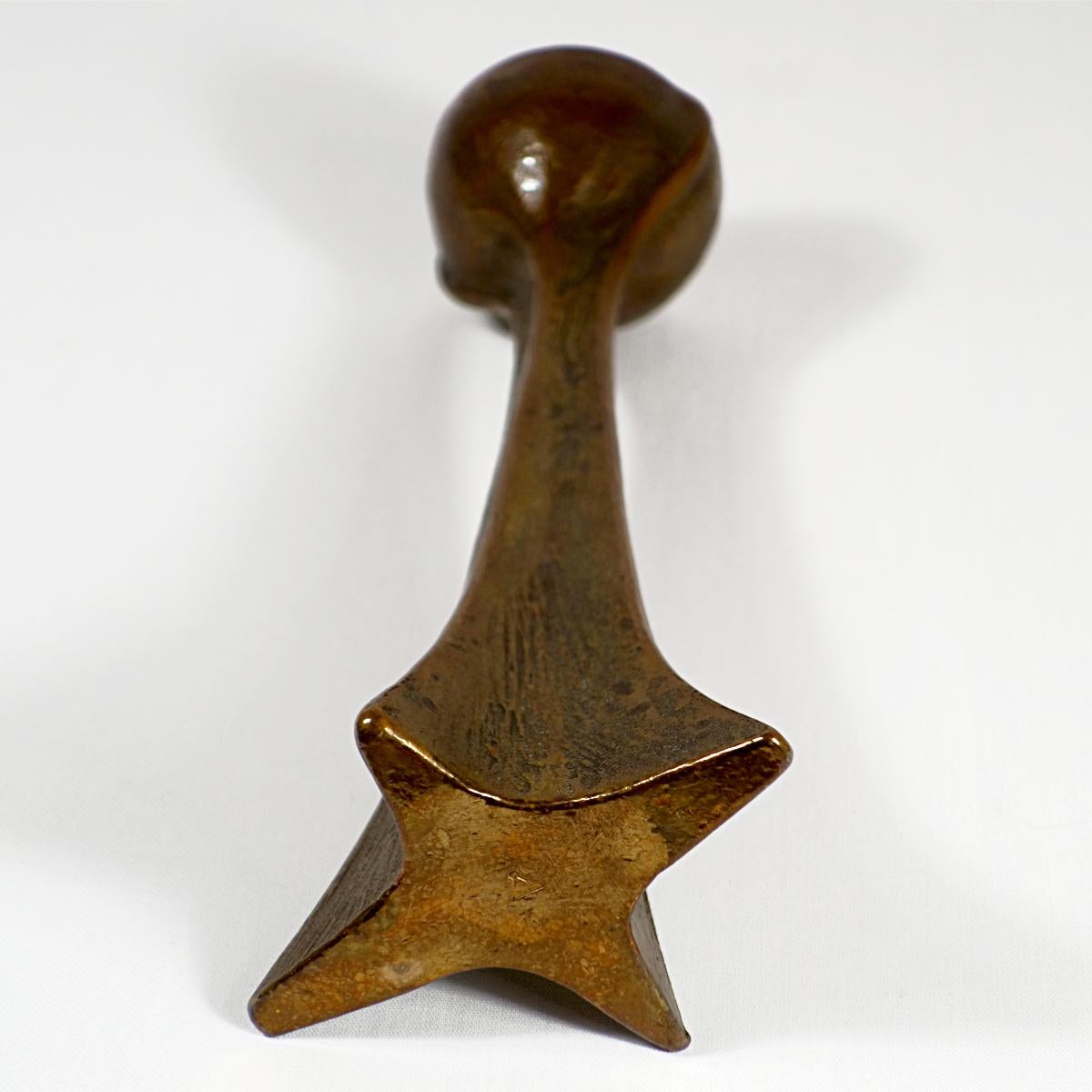 Very tactile and heavy candle stick probably of Scandinavian origin. It is made of cast copper and has a star shaped foot that fluently turns into a round organically shaped top. Both the foot as the top have a beautiful patine.
The candleholder is