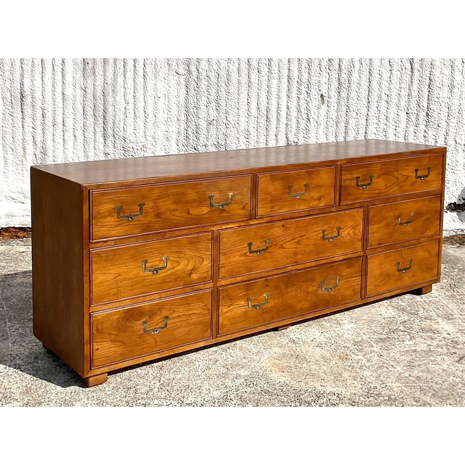 A beautiful midcentury 9 drawer dresser. Made by the iconic Henredon furniture company. Chic brass campaign hardware. Acquired from a Palm Beach estate.