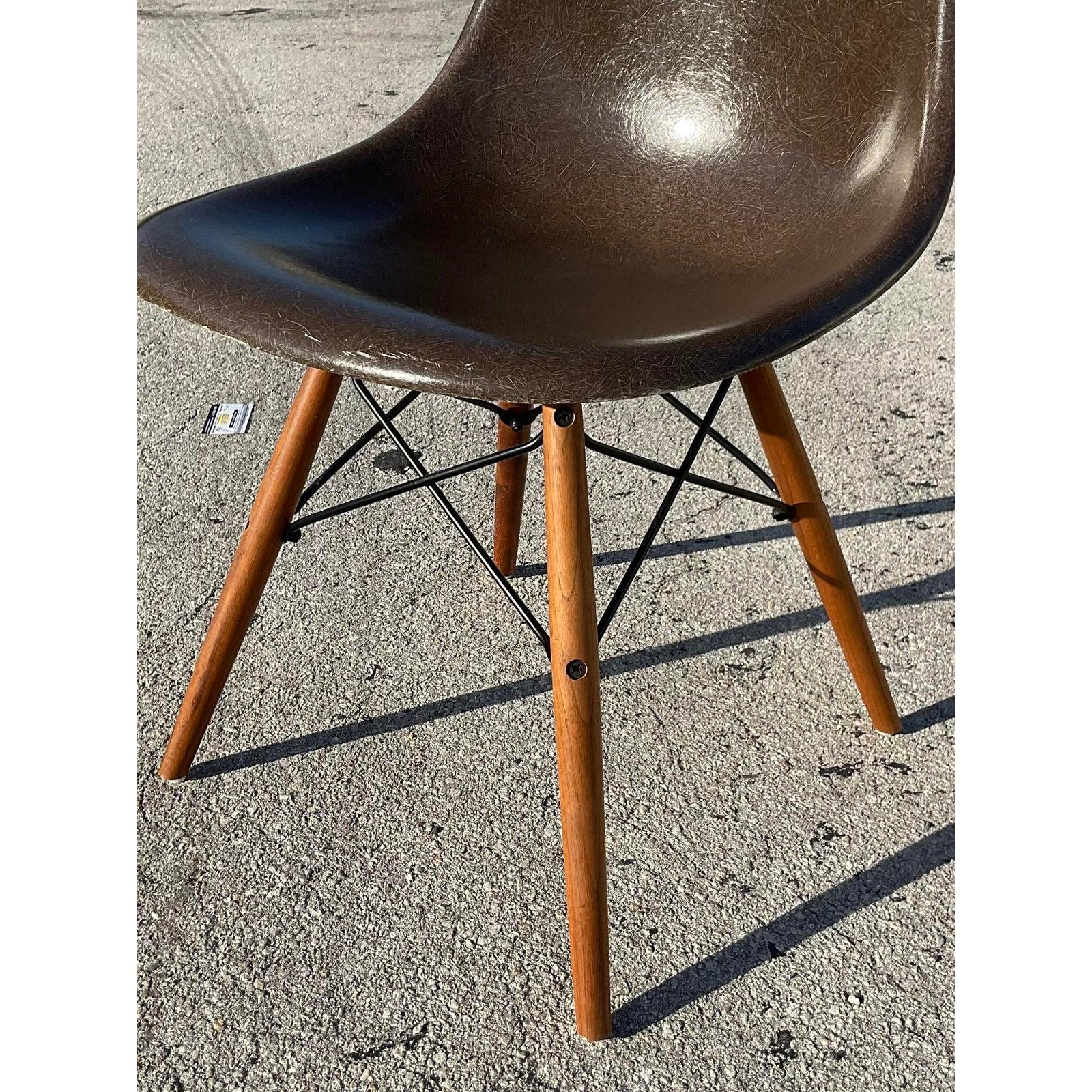 Stunning set of 8 vintage MCM dining chairs. Made by the iconic Herman Miller and tagged on the bottom. The coveted DFSW Shell design with a molded fiberglass seat and the wooden dowel Eiffel Tower pedestal base. These chairs also come with some