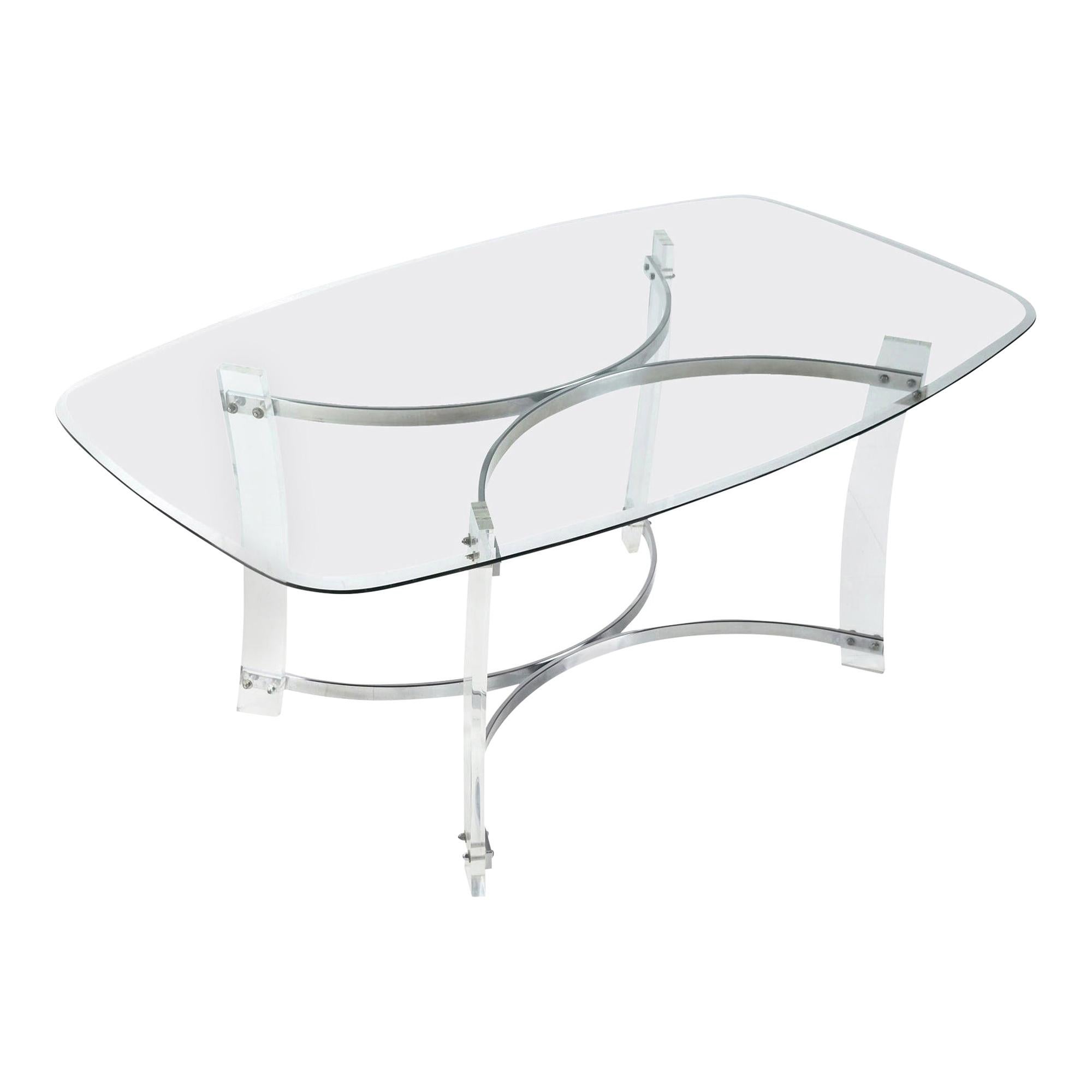 Vintage 1980s Charles Hollis Jones style Lucite and chrome dining table with glass top. The beveled glass top has a bowed, rounded rectangular silhouette mimicking the dynamic contours of the table base. Chrome spanners convex at the bottom and top,
