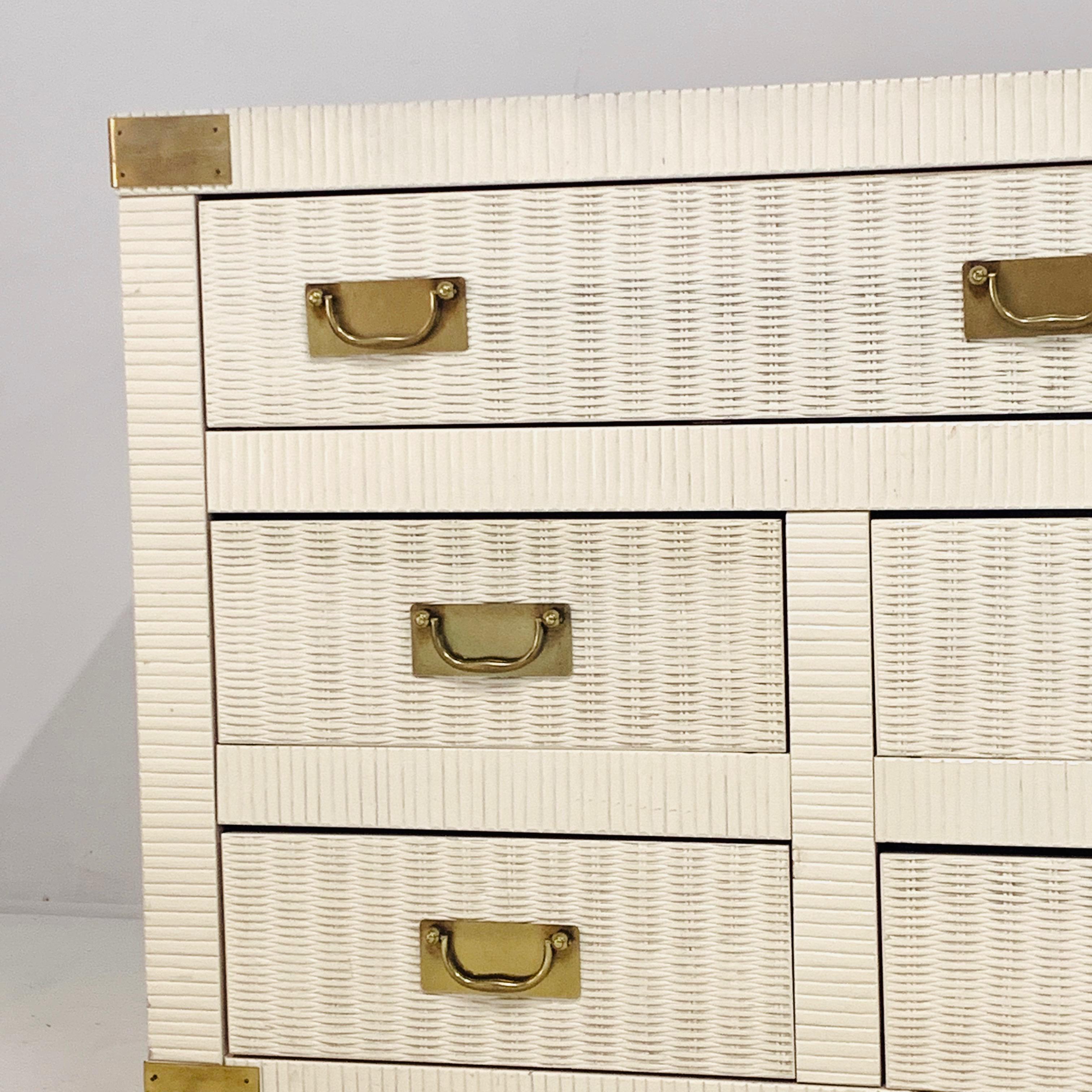 Lovely usable piece perfect for Palm Beach or Hollywood Regency setting. Drawer fronts are painted woven wicker. Sides of case are cream/ white lacquer and dresser top is usable mica so would be perfect for office or kids room.
  