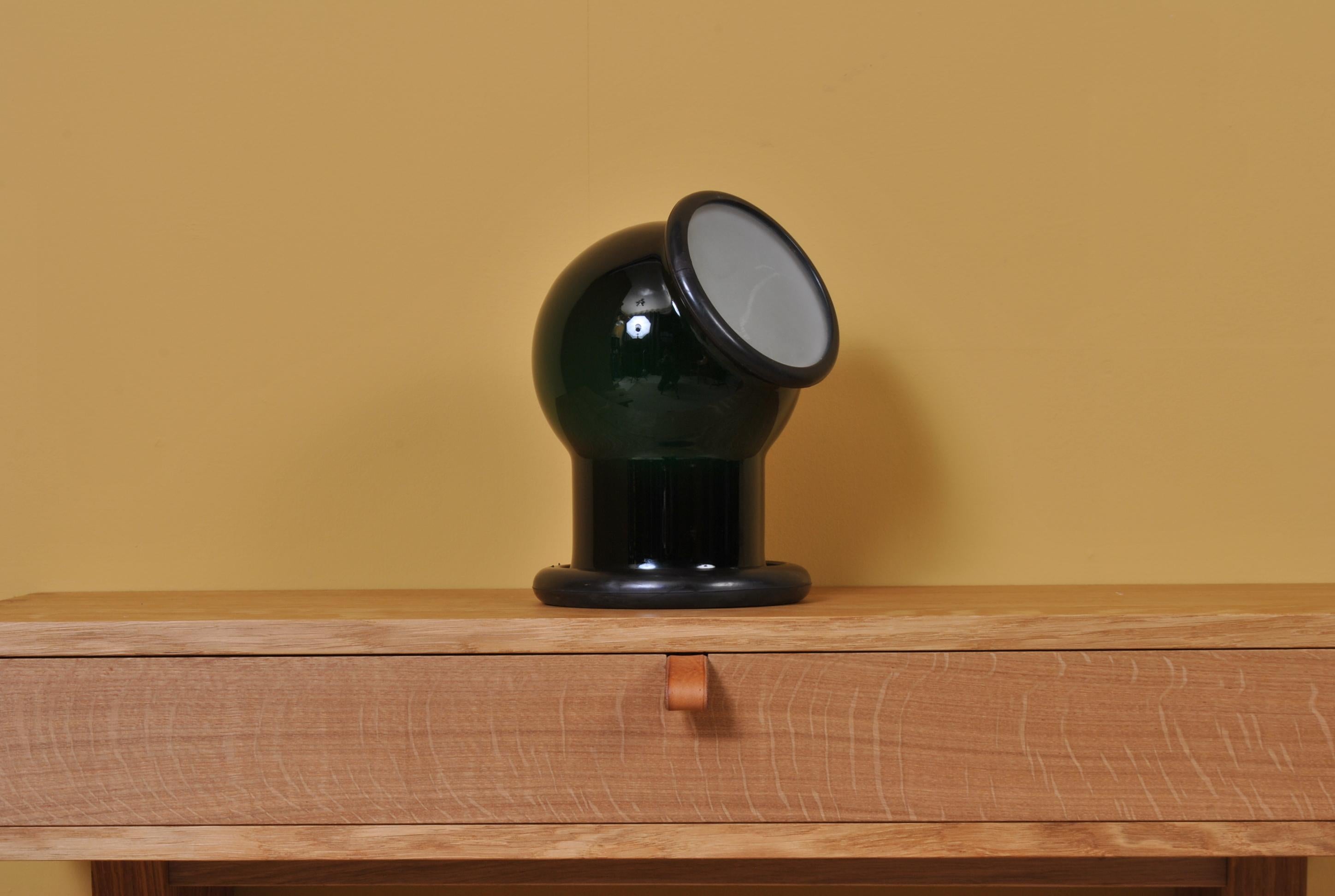 A wonderful midcentury Holmegaard glass Epoke lamp. Designed by Michael Bang for Holmegaard, Denmark, 1972. A playful and characterful design with a slightly nautical nature. Deep green main case with white cap. Heavy glass with rubber