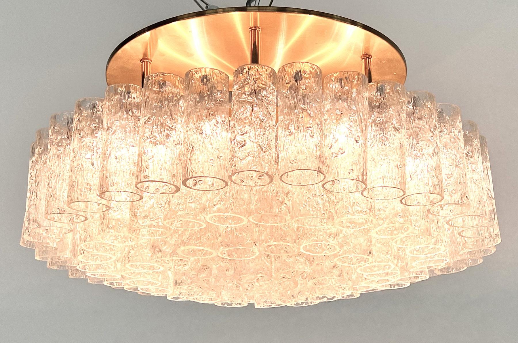Gorgeous big chandelier or flush mount light with brass ceiling plate and 5 levels of 97 ice glasses, all in very good condition.
Made in Germany in the 1970s by DORIA.
The ceiling plate is equipped with 9 bulb holders for small candelabra bulbs and
