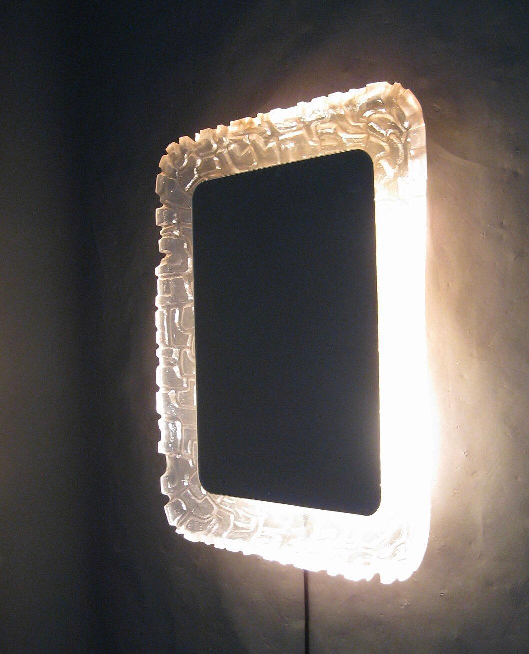Large illuminated mirror made by Erco Lucite in 1960-1970. Backlight and textured Lucite frame, shaped to resemble ice glass.
 