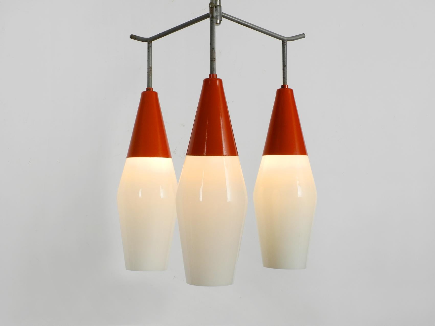 Very rare midcentury Industrial ceiling lamp by Josef Hurka for Napako.
The frame is made of metal, the three shades are made of high quality thick glasses.
Very nice minimalistic design with great patina. Made in the Czech Republic.
100%