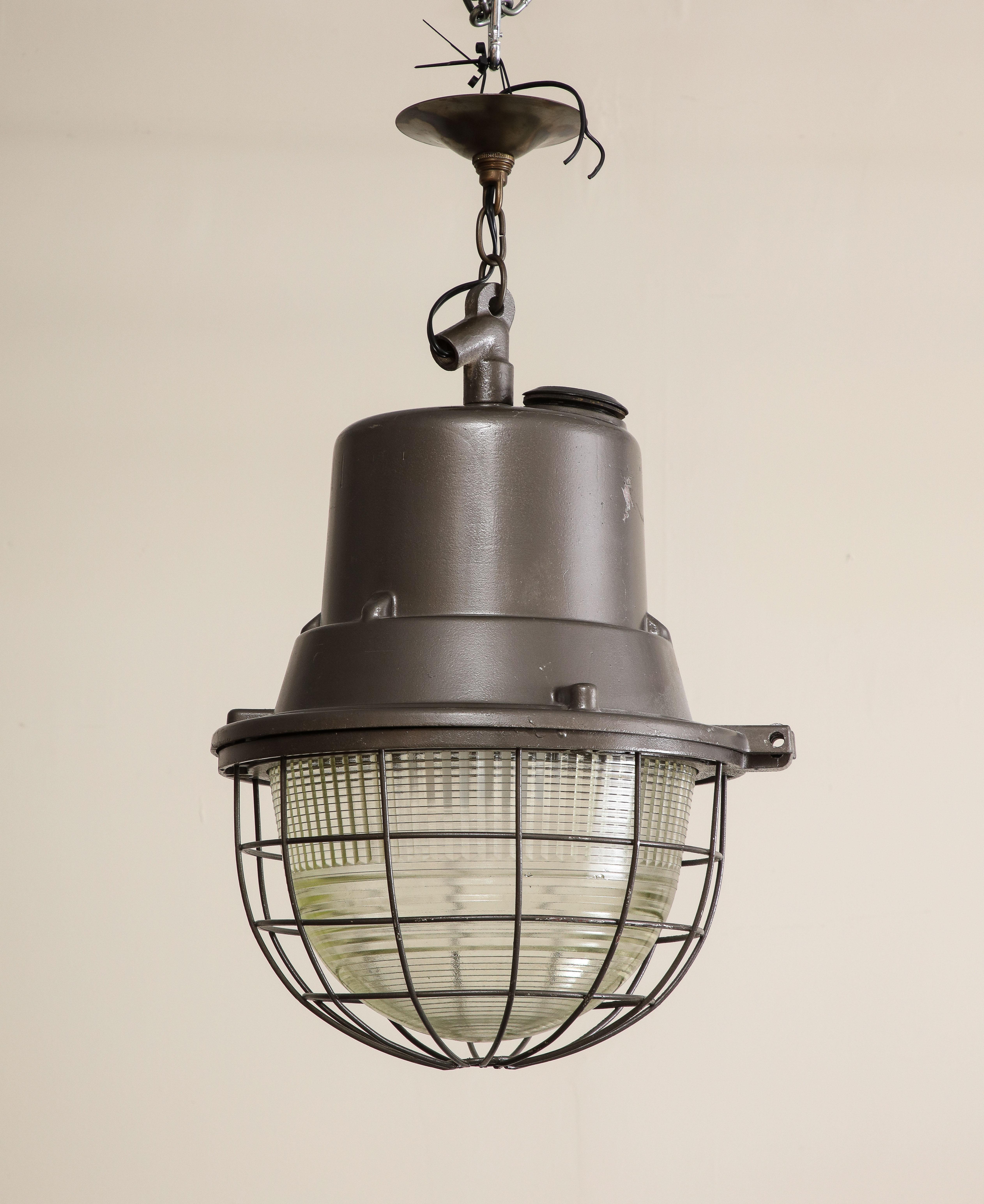 1940s midcentury industrial style pendant light with original glass and steel cage. Wired for USA, in good working condition.