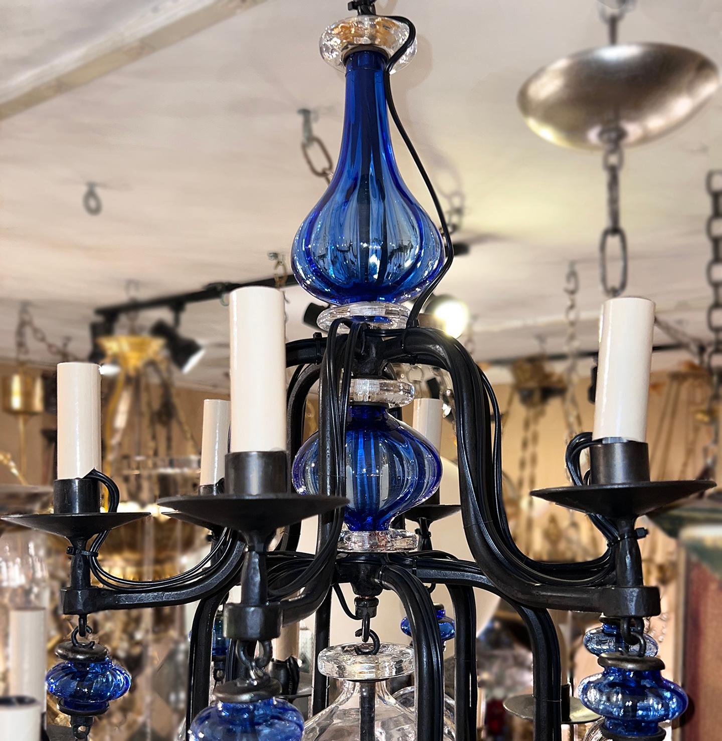 A circa 1970's Swedish iron chandelier with blown blue glass insets.

Measurements:
Current drop: 27