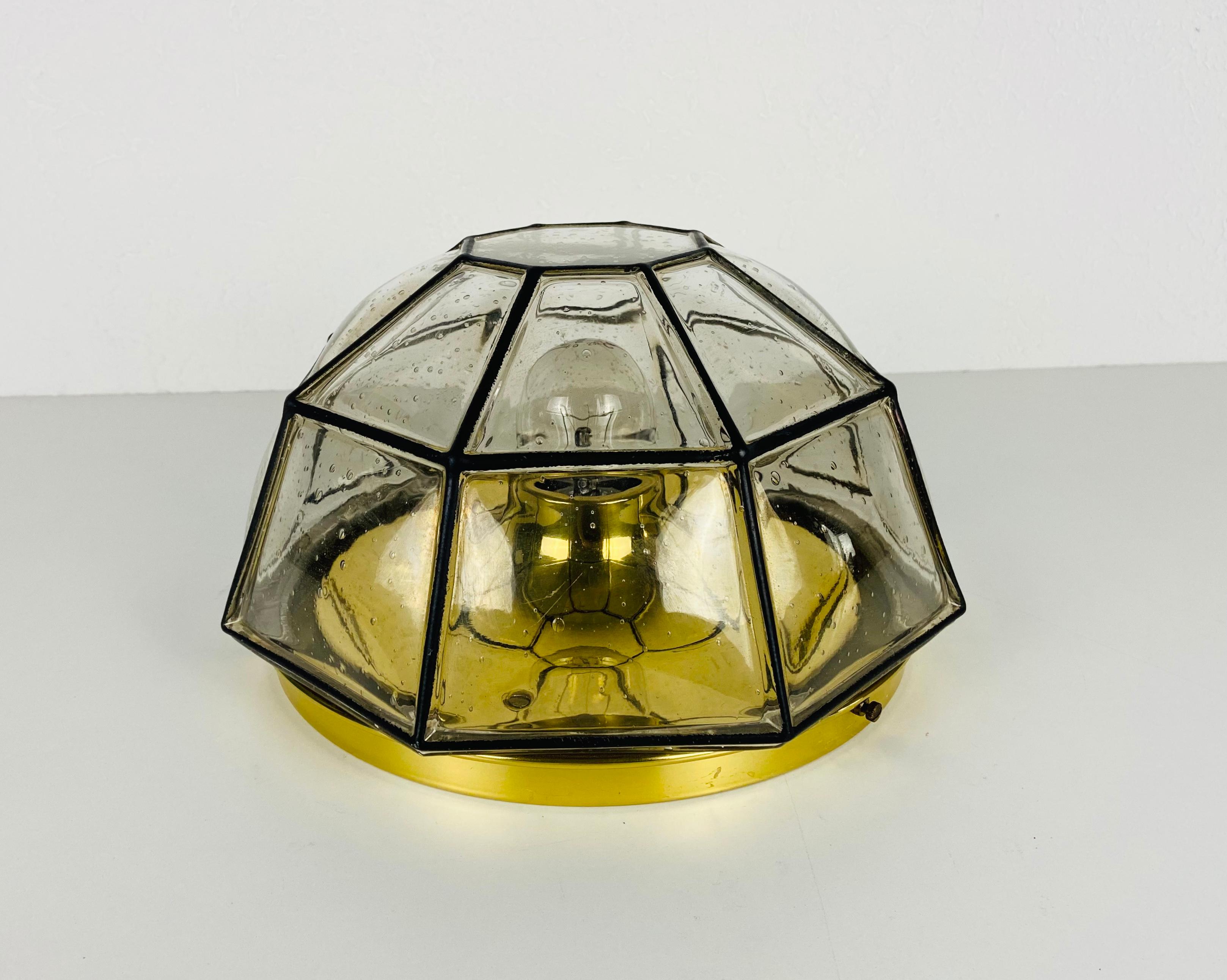 A Mid-Century Modern flush mount by Glashütte Limburg made in the 1960s in Germany. It is fascinating with its beautiful square shape and bubble glass. The fixture has a very nice Minimalist design.

The light requires one E27 (US E26) light bulb.