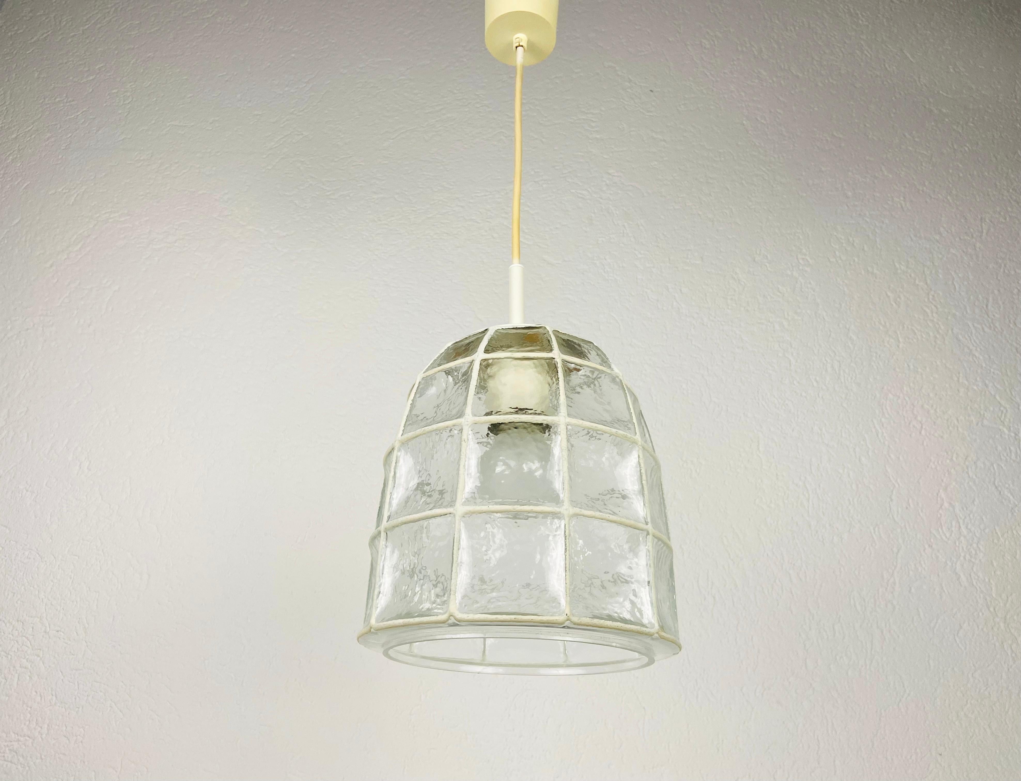A Mid-Century Modern pendant lamp by Glashütte Limburg made in the 1960s in Germany. It is fascinating with its beautiful shape and bubble glass. The fixture has a very nice Minimalist design.

The light requires one E27 (US E26) light bulb. Works