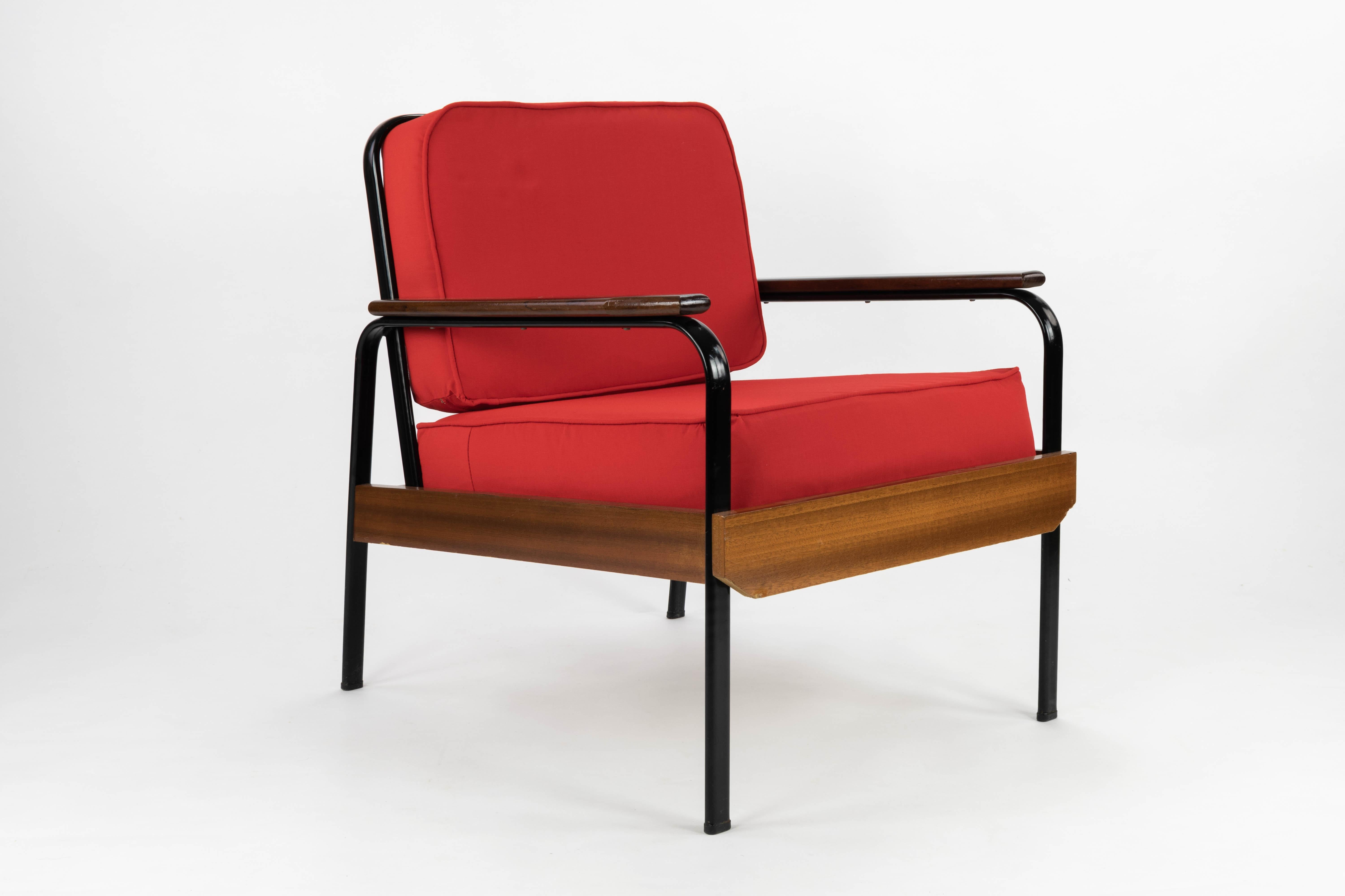 Set of sofa bed and couple of armchairs circa 1950, France. Industrial and functional model, with influence and similarity to those designed by Prouve. Iron structures lacquered in black with wood. New upholstery in red canvas.