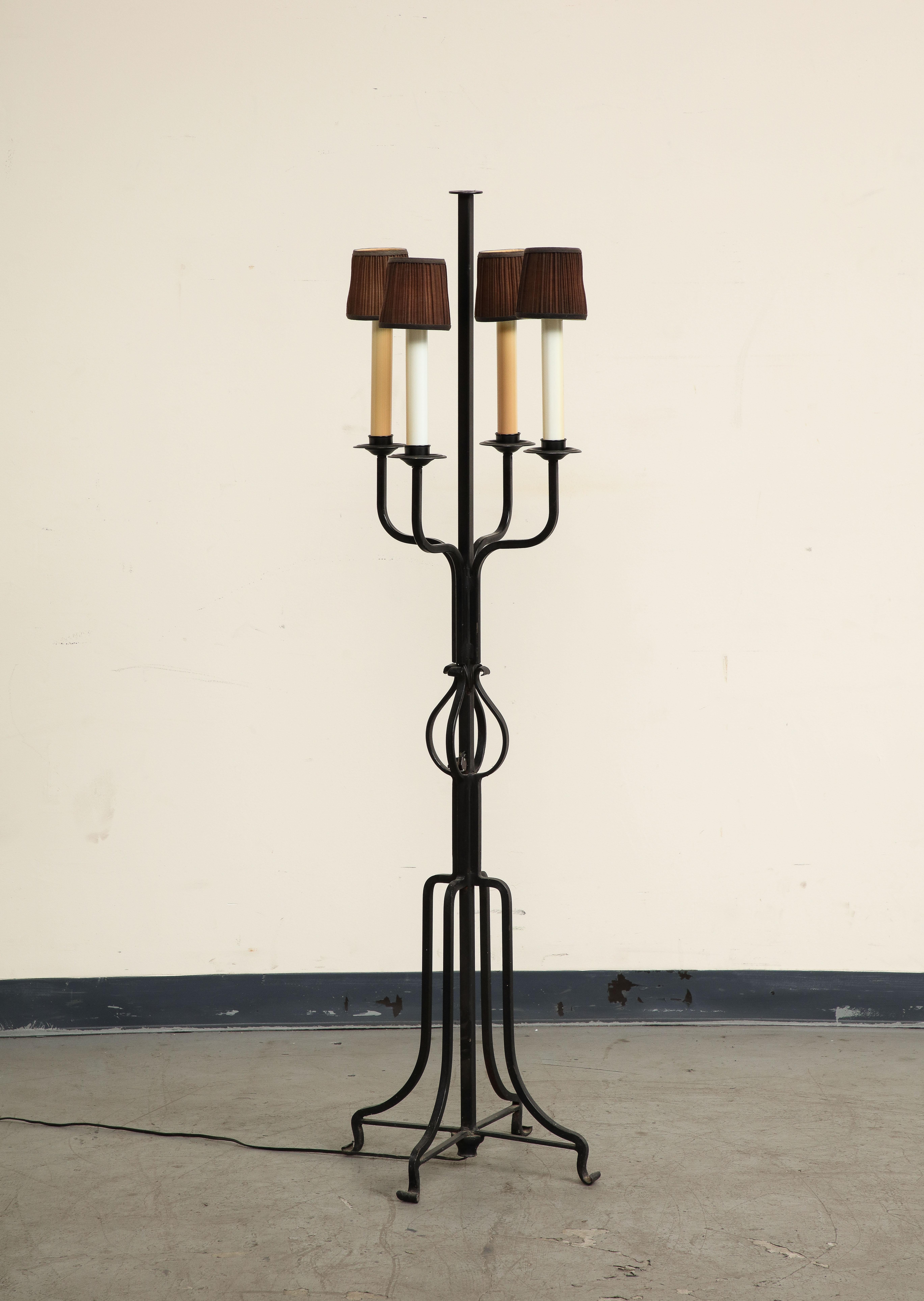 Midcentury iron candlestick floor lamp, attributed to Tommi Parzingers. Four (4) candles with brown fabric shades. Missing finial. Not tested, likely needs to be rewired. 

Additional Dimensions: 
candle height 11.25
