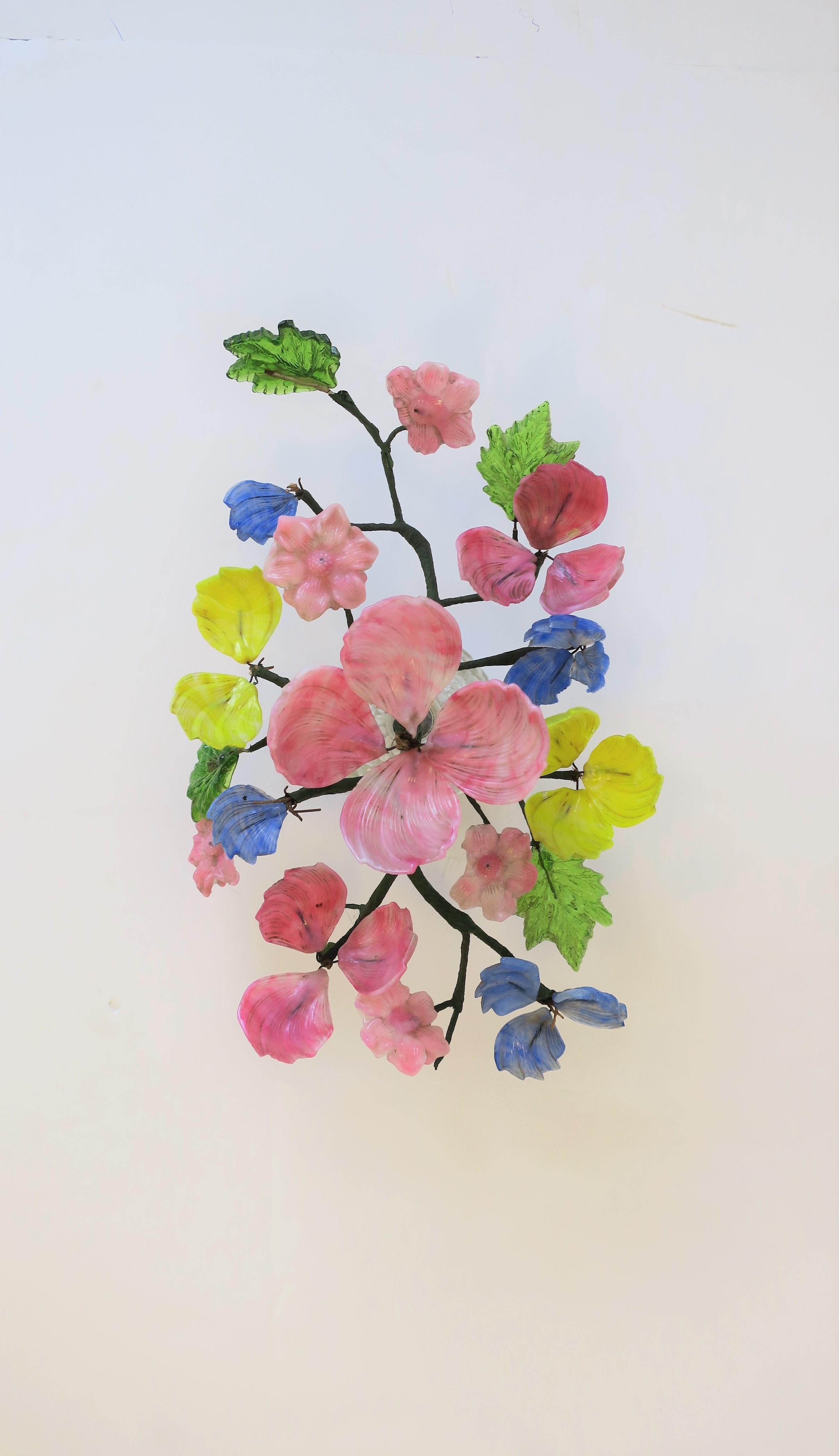 A very beautiful Mid-20th century Italian art glass floral arrangement sculpture piece. Art glass flower and leaf colors include, blue, pink, yellow and green, with mounting to a clear art glass base.

Piece measures: 13