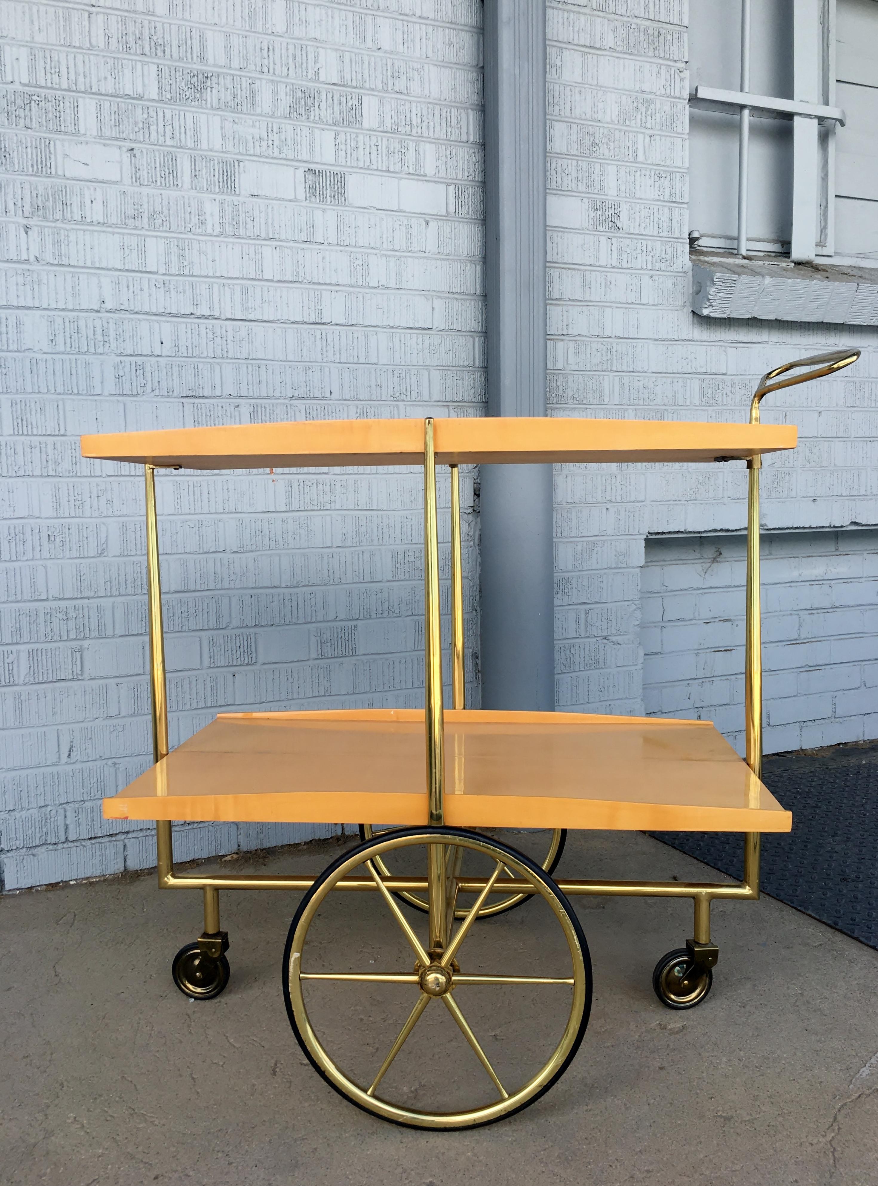 1950s vintage Italian modernist bar car or trolley with two lacquered birch trays and sculptural brass frame and handle. Retains the original Mod. Dep. Made in Italy metal tag to underside of one tray which is commonly found on the carts from Cesare