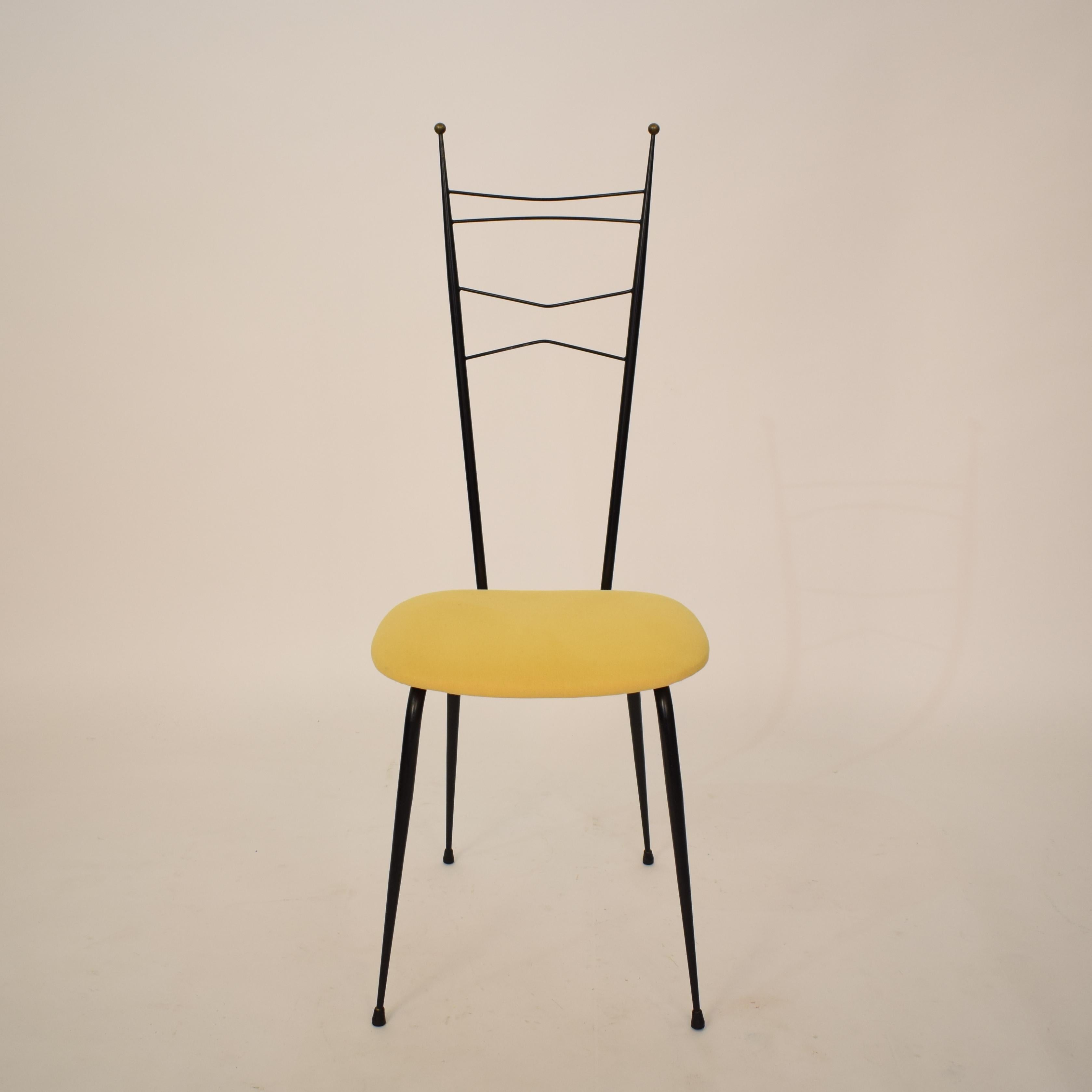 This extraordinary midcentury Italian black and yellow dining room chairs attributed to Ico Parisi and Paolo di Poli is made out of black lacquered metal, brass and yellow fabric.
It is in beautiful untouched original condition and I bought it out