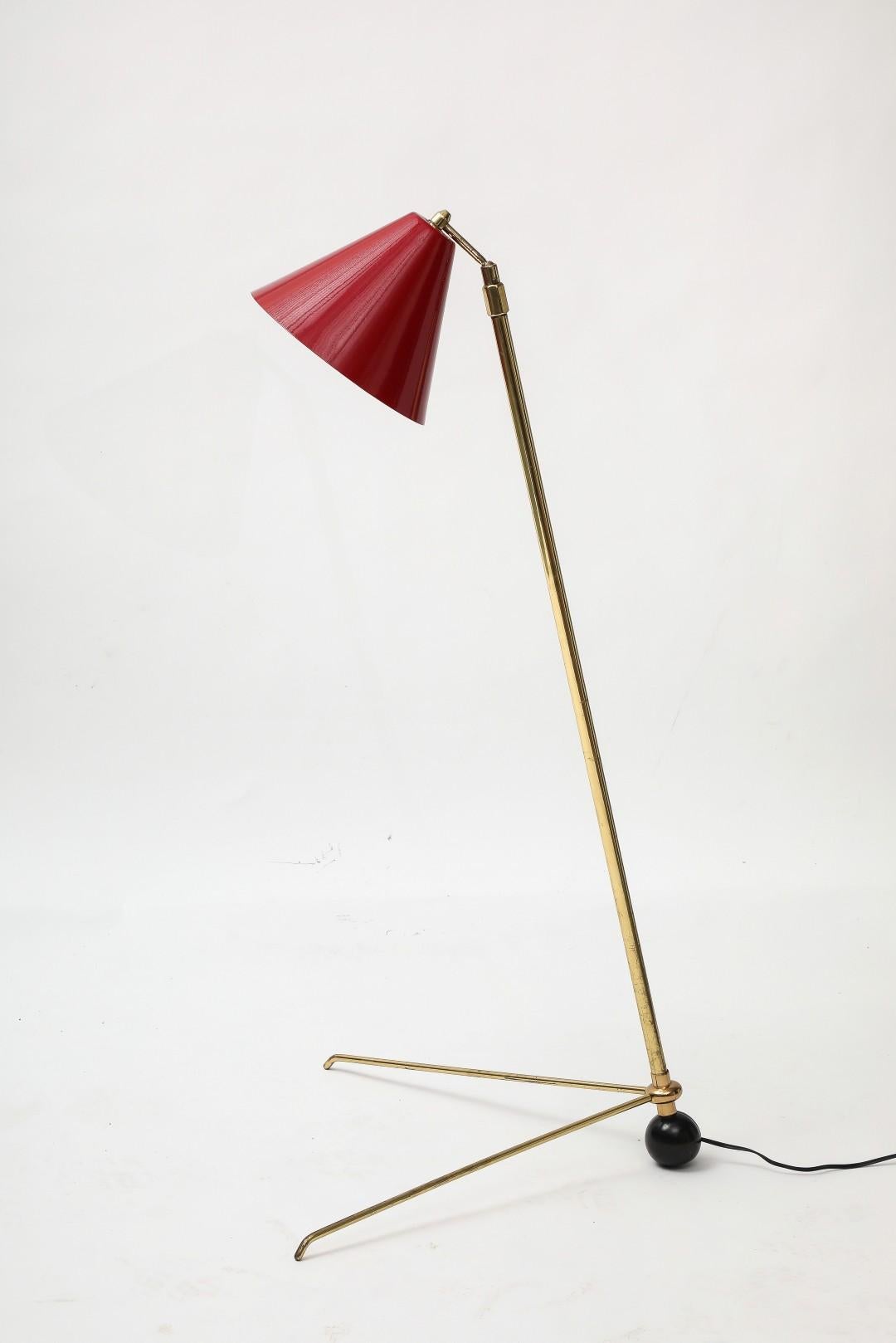 1950s Midcentury Modern Italian brass adjustable floor lamp with red enameled metal shade. The V-shaped base can slide along the stem. Wired for USA. 

Shade: 8.25