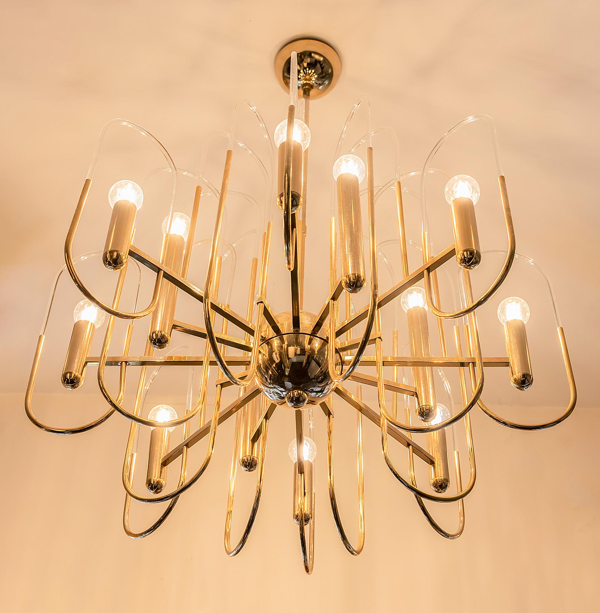 Italian midcentury chandelier. It is made of polished brass and clear glass in the holders.
This chandelier includes 12 pieces. E14 bulbs.
Its is in a very good original vintage condition.
  
 