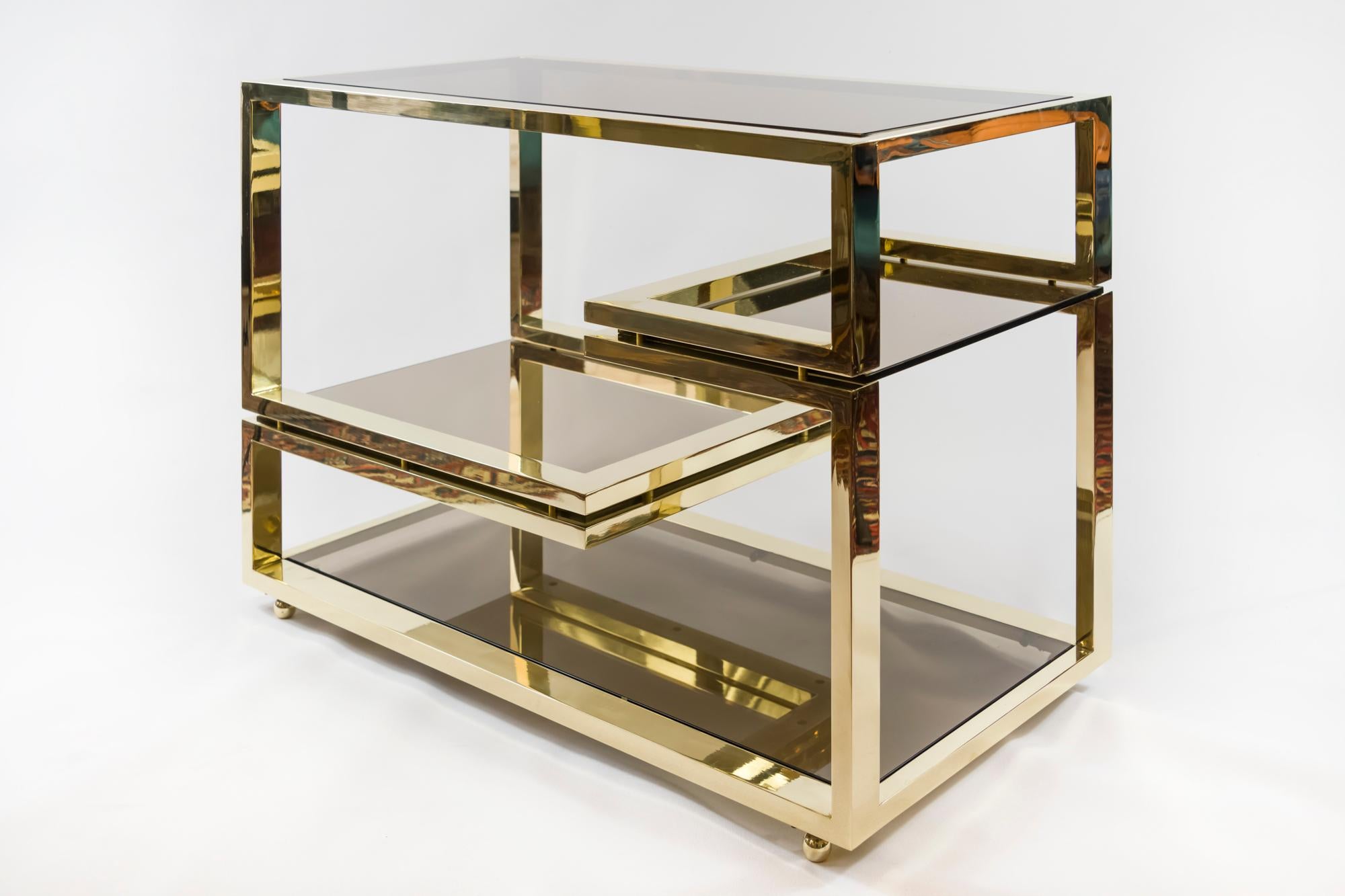 This midcentury Italian serving table is made of brass with smoked glass top, bottom and two shelves .
It is heavy and solid, very good condition.