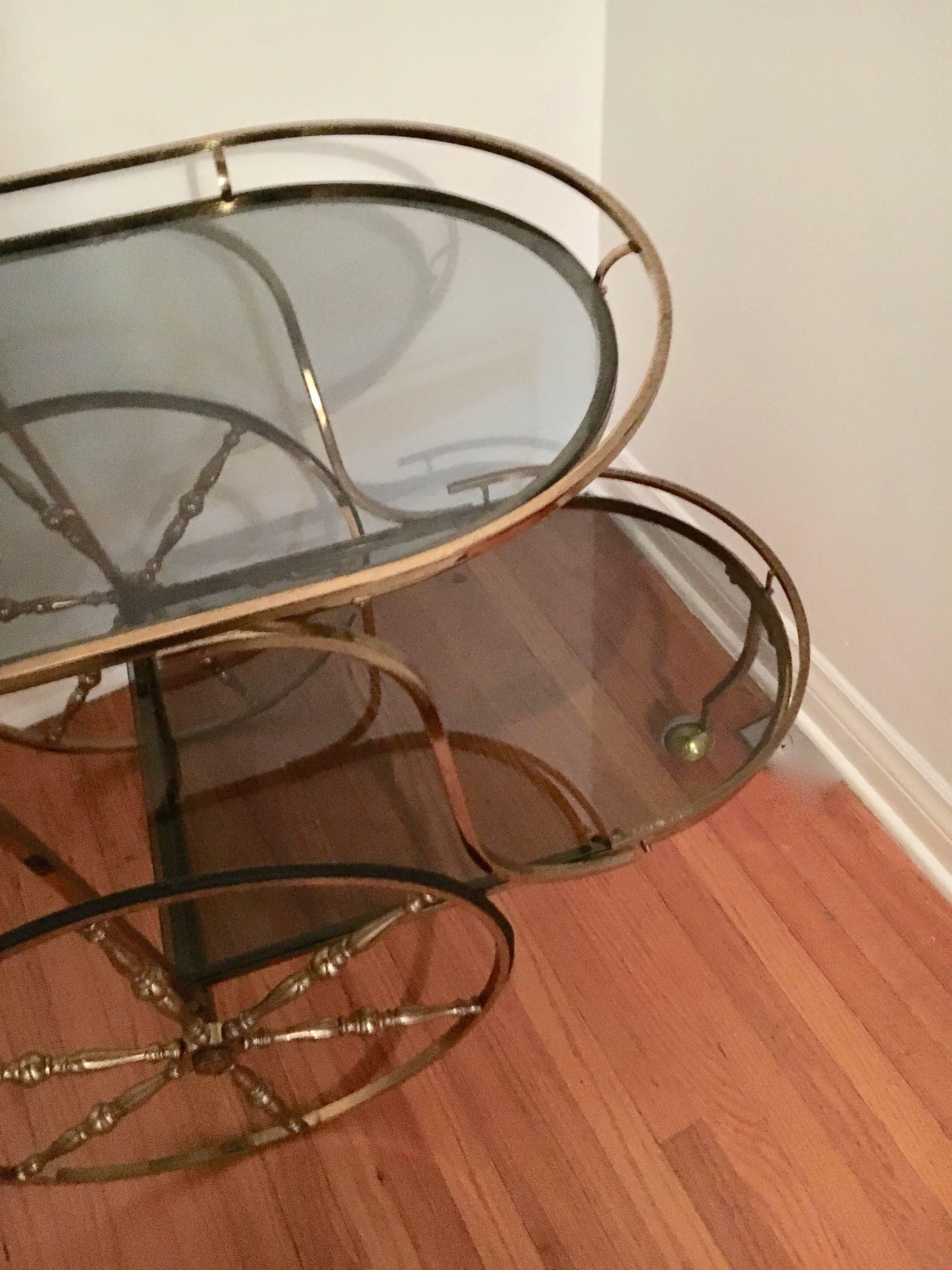 Midcentury Italian brass bar cart - two levels and three large wheels - two larger and one caster... great for any room with spirits that can travel! We have added new glass on both levels - smoked glass for a sexier bar!.