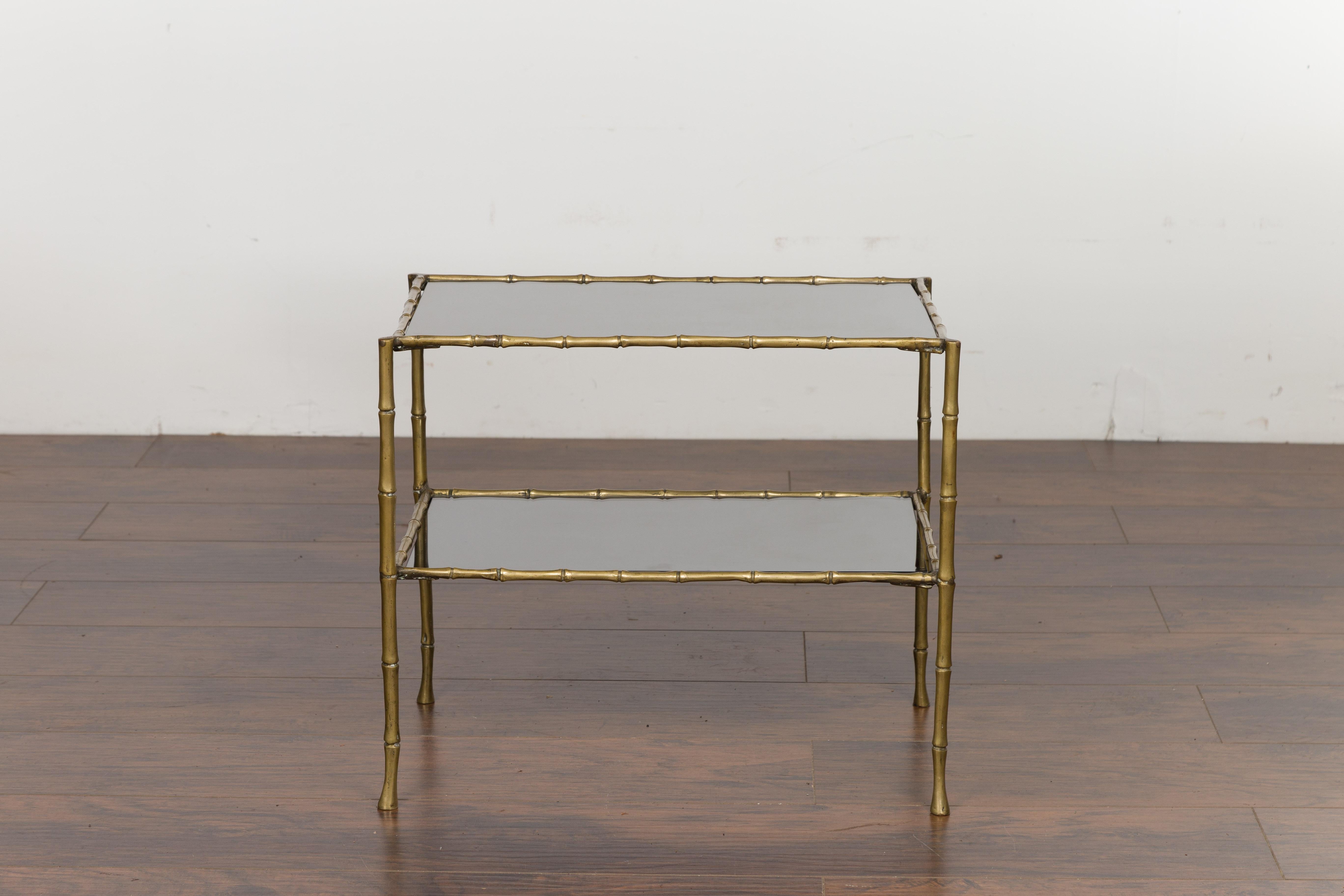 An Italian vintage brass faux bamboo drinks table from the mid 20th century, with mirrored top and shelf. Created in Italy during the midcentury period, this drinks table features a rectangular mirrored top supported by four brass faux bamboo legs