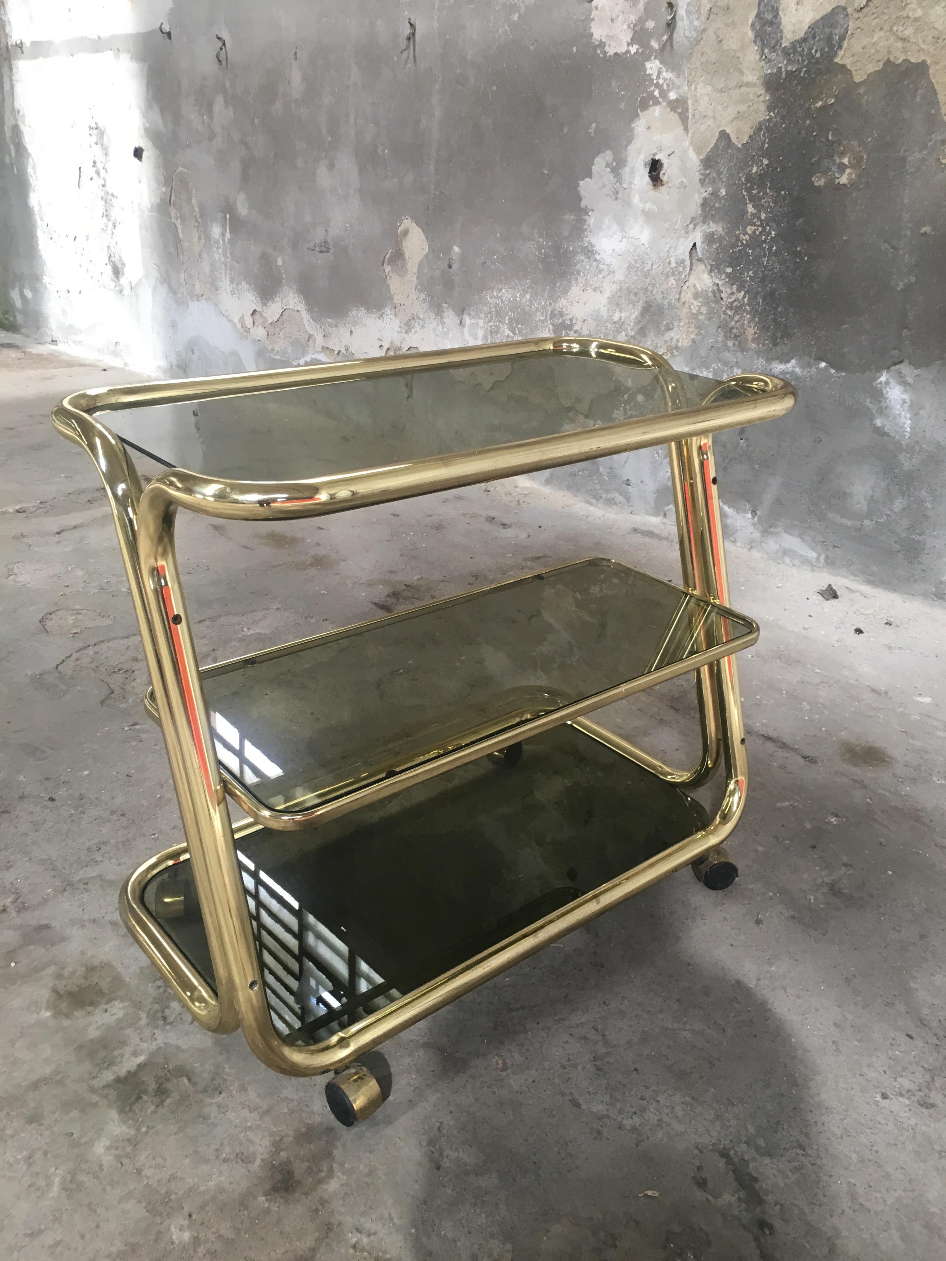 Mid-Century Modern Italian brass metal bar cart with smoked glass shelves from 1970s.