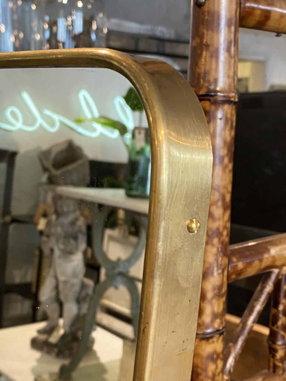 Beautiful Italian mirror from the 1950s, almost square, with a lovely clean sleek shape. The mirror is stylistically related to the designer Giò Ponti’s brass mirrors, and has suspension brackets mounted on the back.