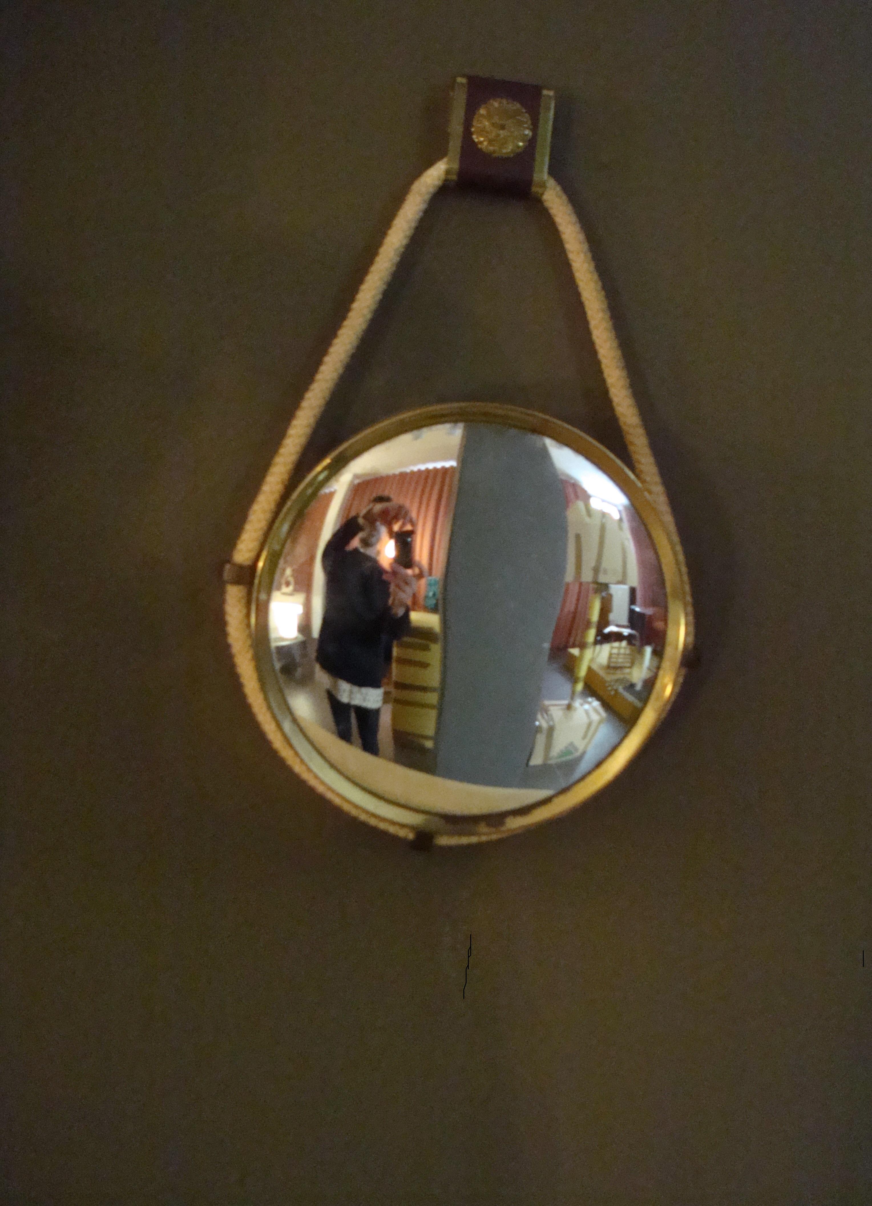 Mid-20th century Italian brass round convex mirror, circa 1960 mounted with a navale rope, with brass rings, the whole hung with a leather and brass support. Perfect for a marine-style interiors or a classic and modern home.
