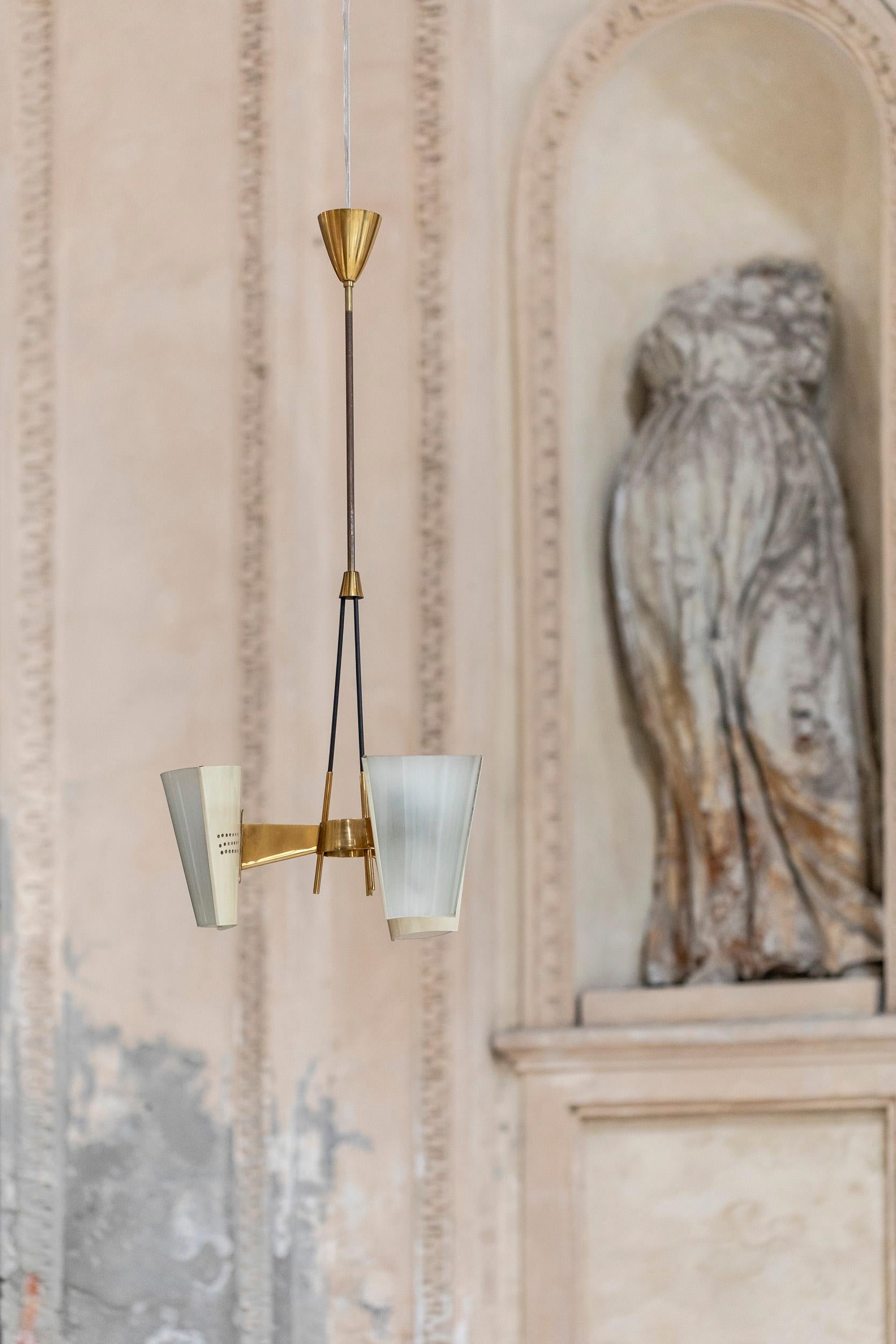 Stunning three lights pendant by Stilnovo. 
Every light was realized with a brass , glass  and white laquered metal lampshades with elegant brass details. 
Perfect vintage condition 
Italy, 1960