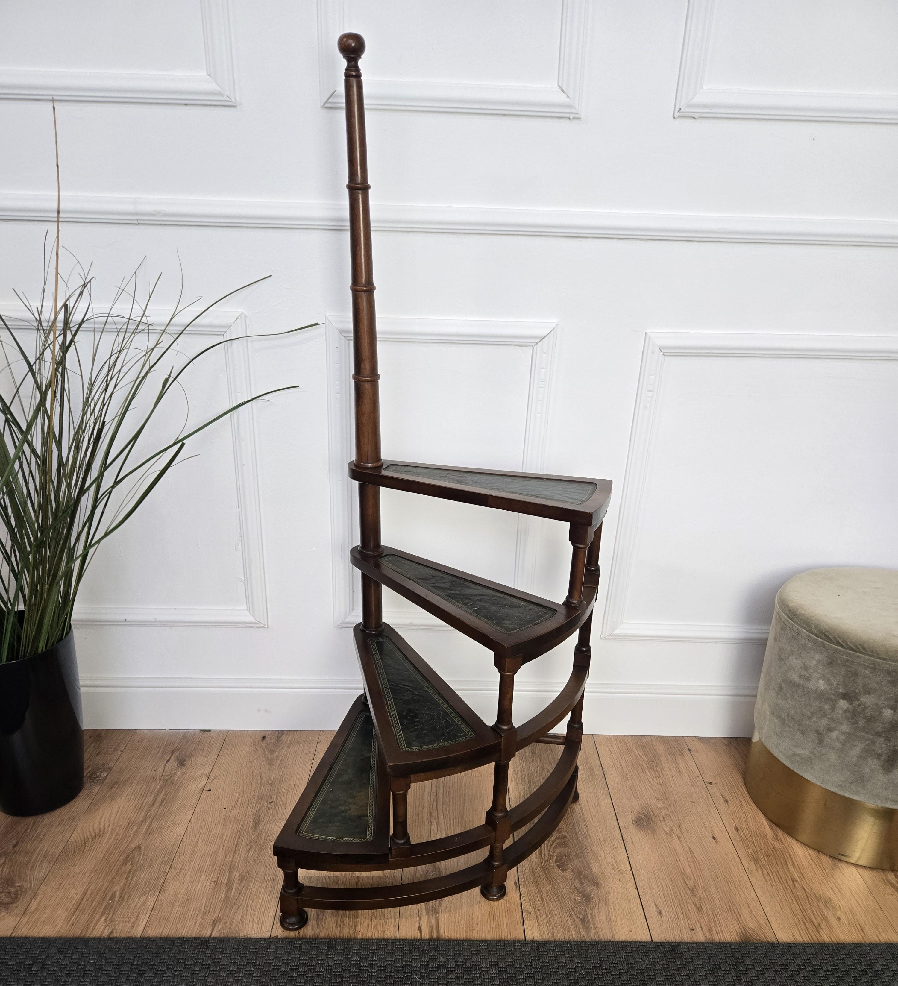Beautiful Italian carved walnut wood circular step ladder with four stairs rolled around a turned, central pole with a decorative finial. Each step is upholstered with green leather and golden classic frame. Versatile and practical, the elegant