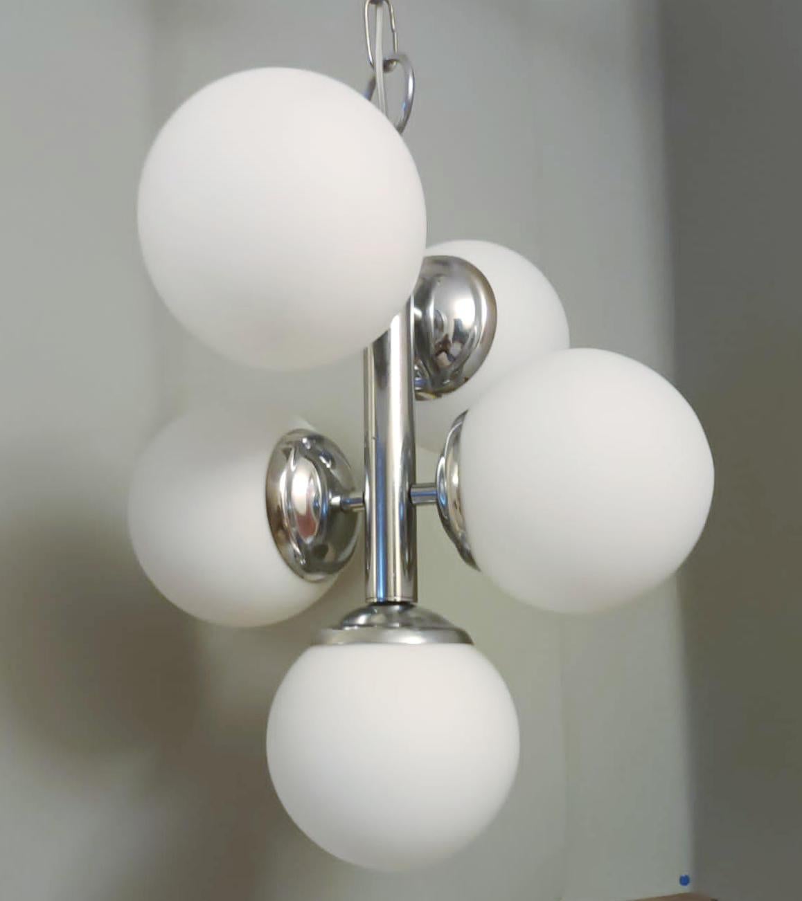 Vintage Italian chandelier with a cluster of five matte white opaline glass globes mounted on chrome structure / Made in Italy circa 1960s
Measures: diameter 14 inches, height 18 inches, total height 30 inches including chain and canopy
5 lights /