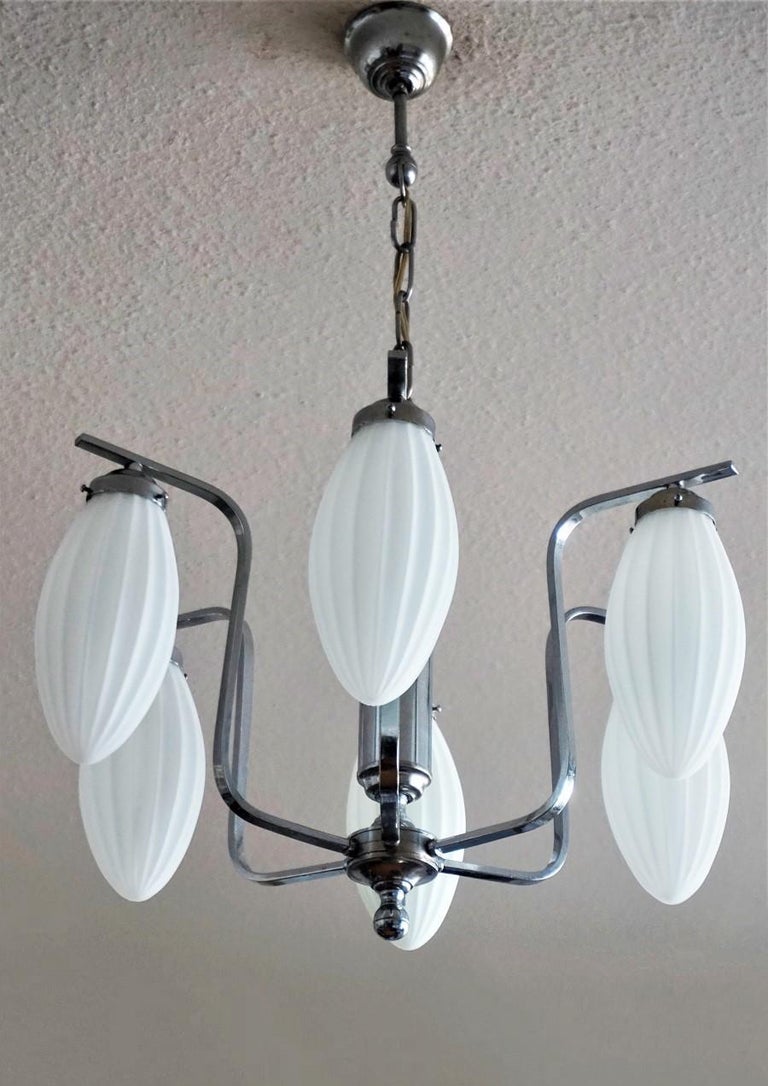 A chromed chandelier with six satin white fluted glass globes, Italy, 1960s
The glass globes are in very good condition, chrome with some wear, rewired.
Measures:
Overall height 30