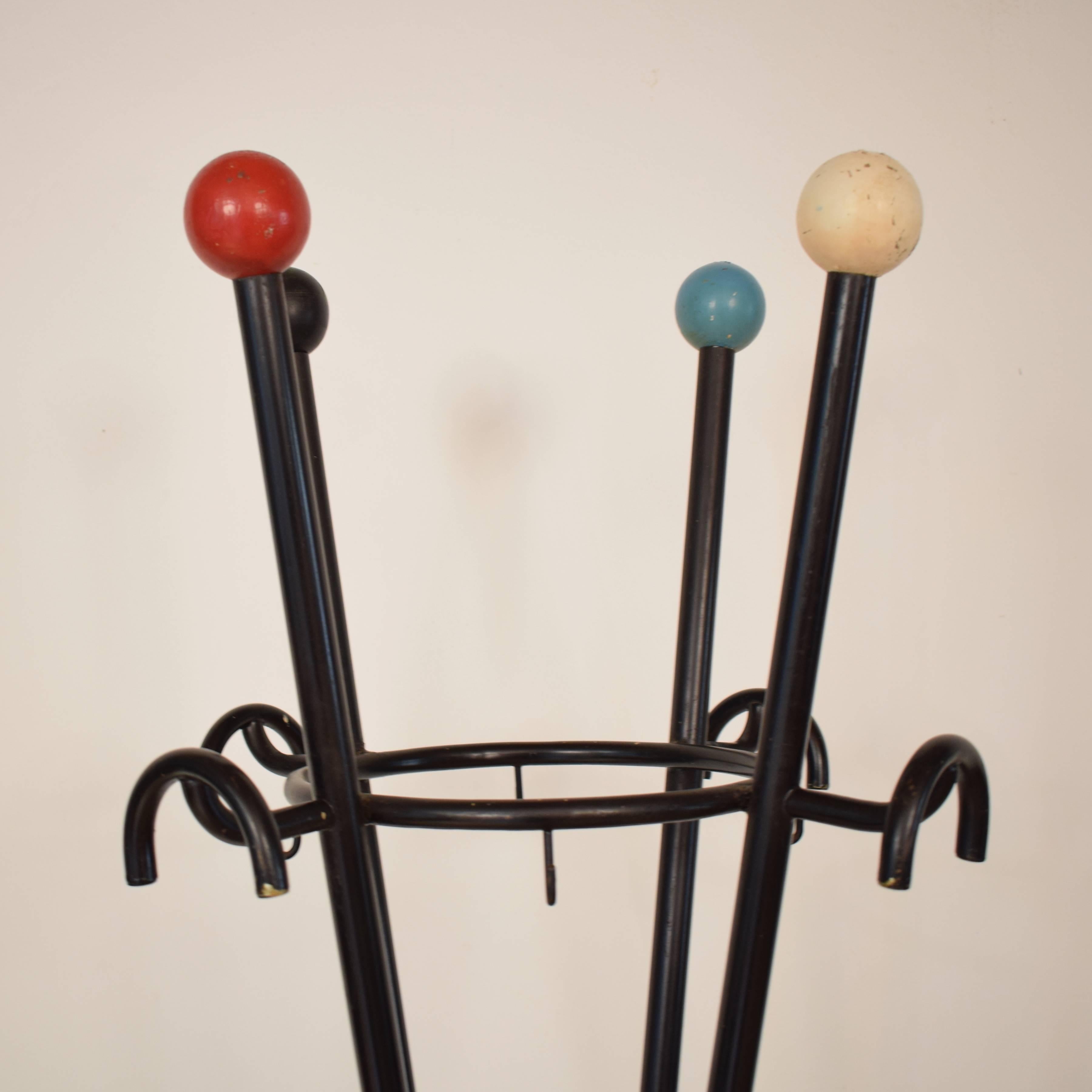 This large midcentury coat rack was made in Italy in the 1960s. It is lacquered metal and on top there are wooden balls in four different colors.
  